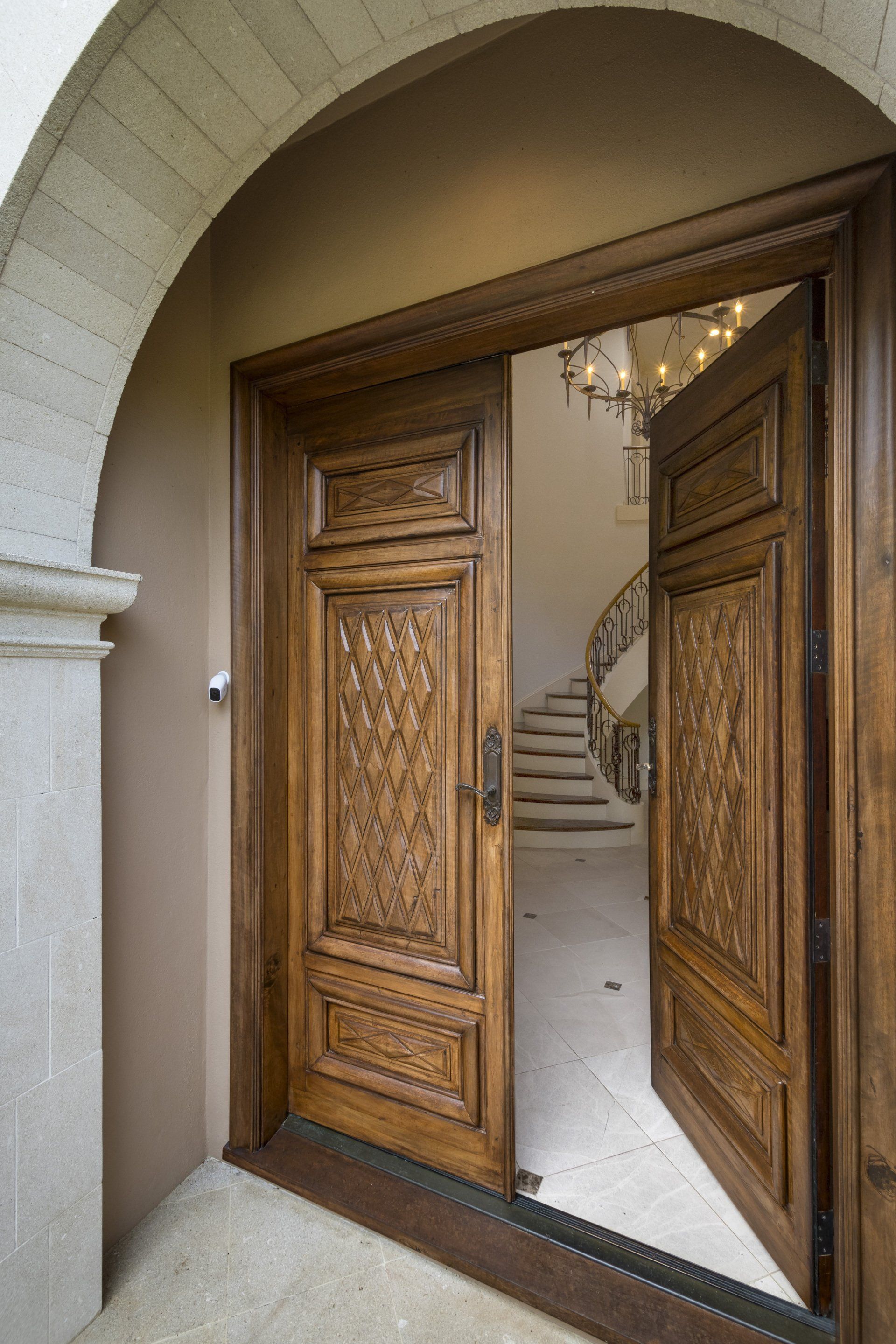 A large wooden door is open to a staircase