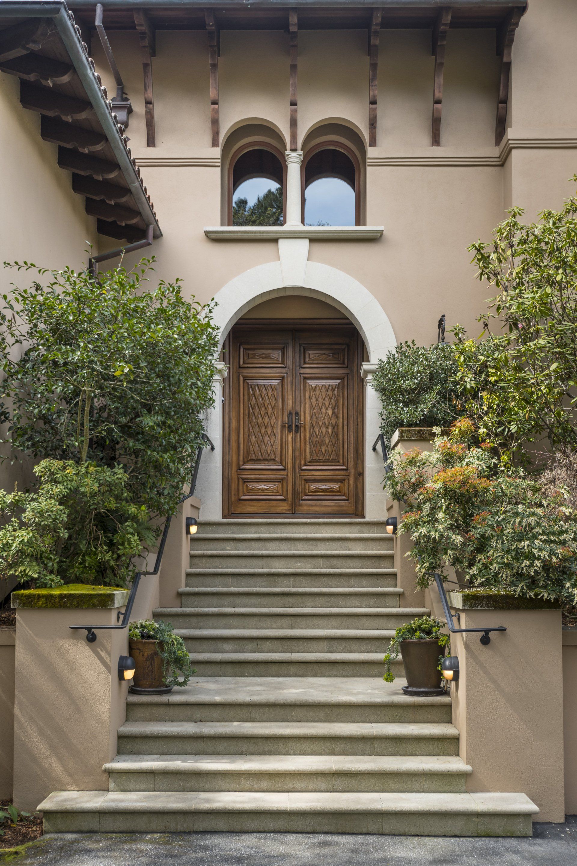 The front door of a house with stairs leading up to it