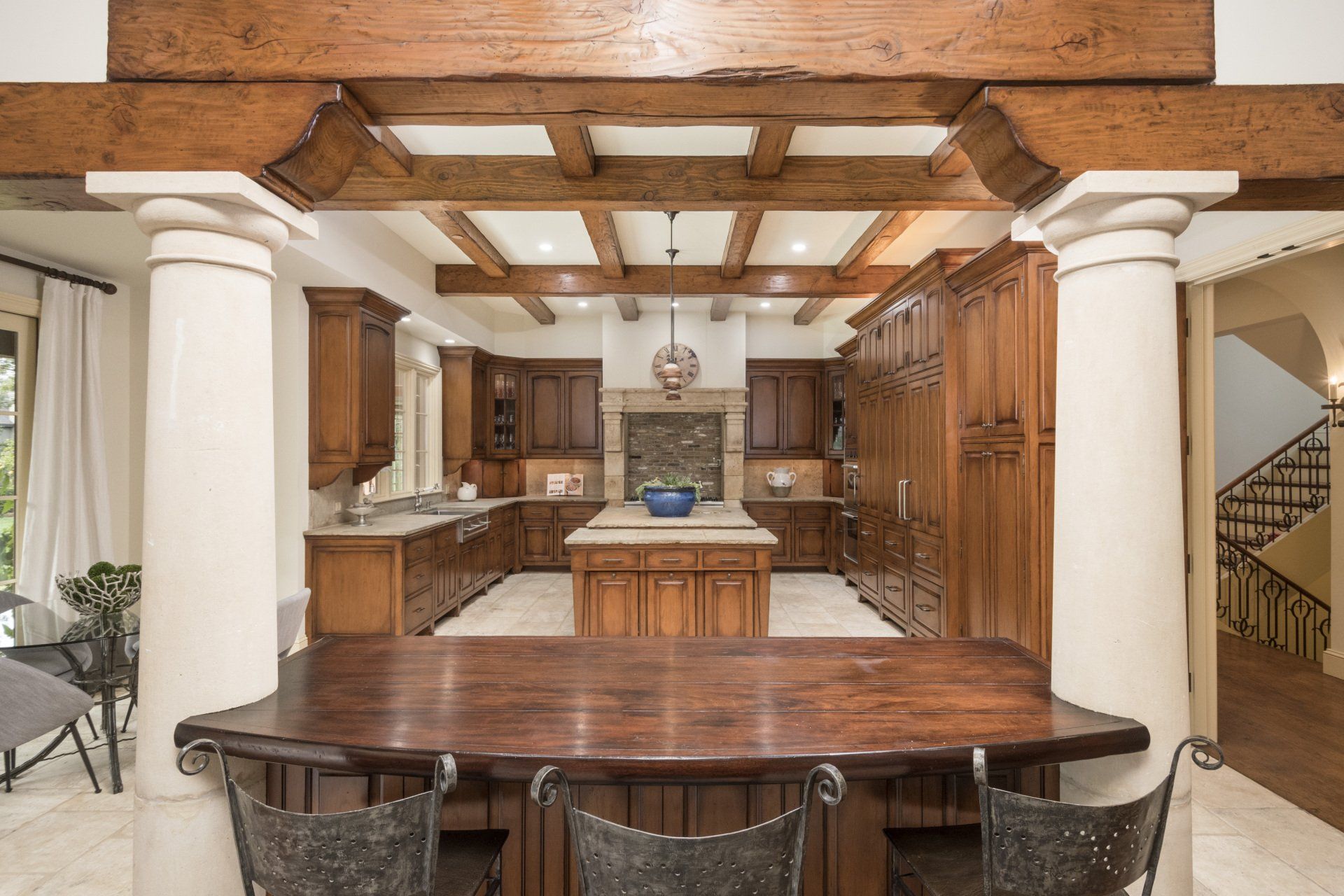 A kitchen with a large wooden table and chairs