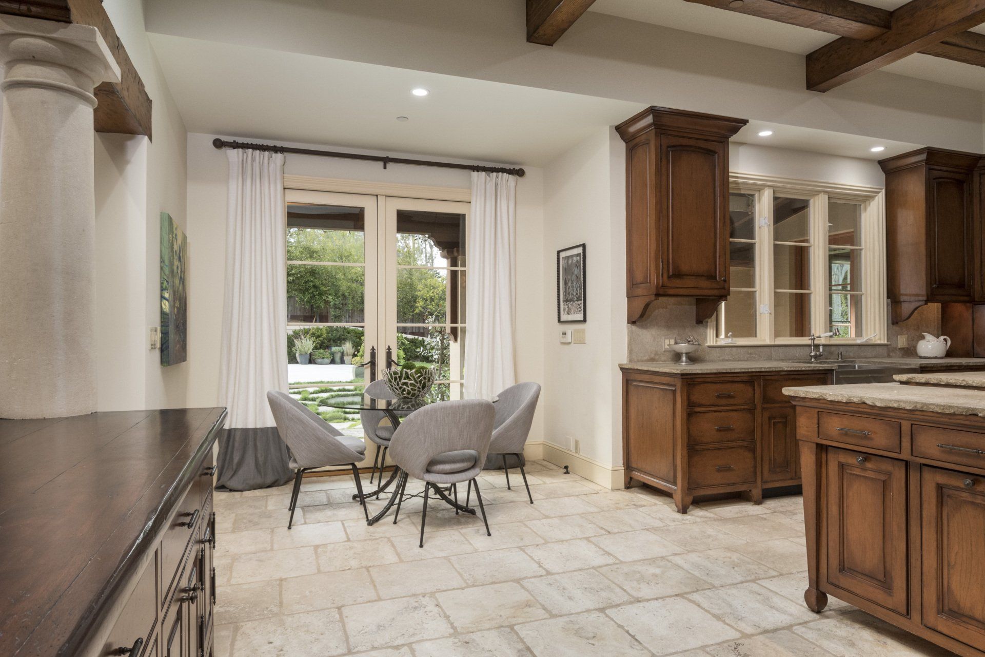 A kitchen with a table and chairs in it
