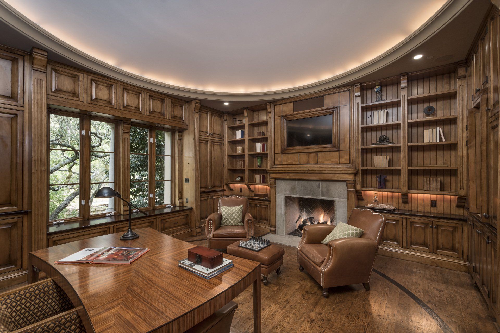 A living room with a fireplace and a desk