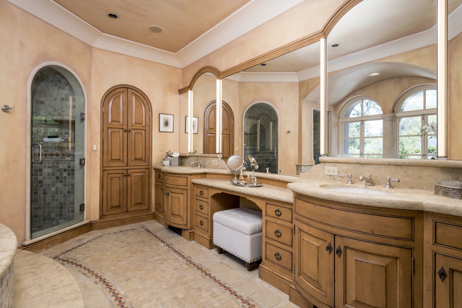 A bathroom with a lot of cabinets and mirrors