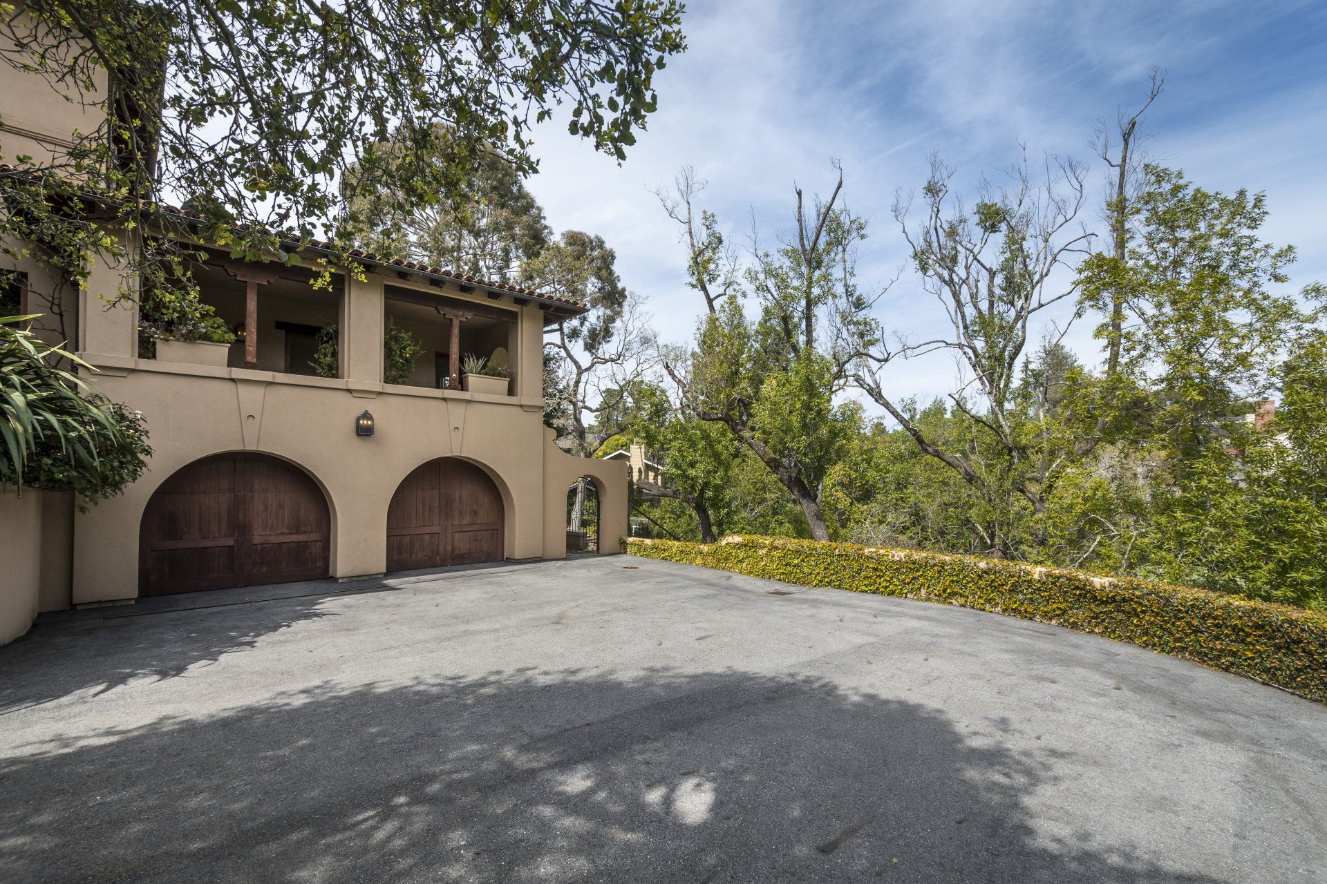 A large house with a lot of garages and trees in the background