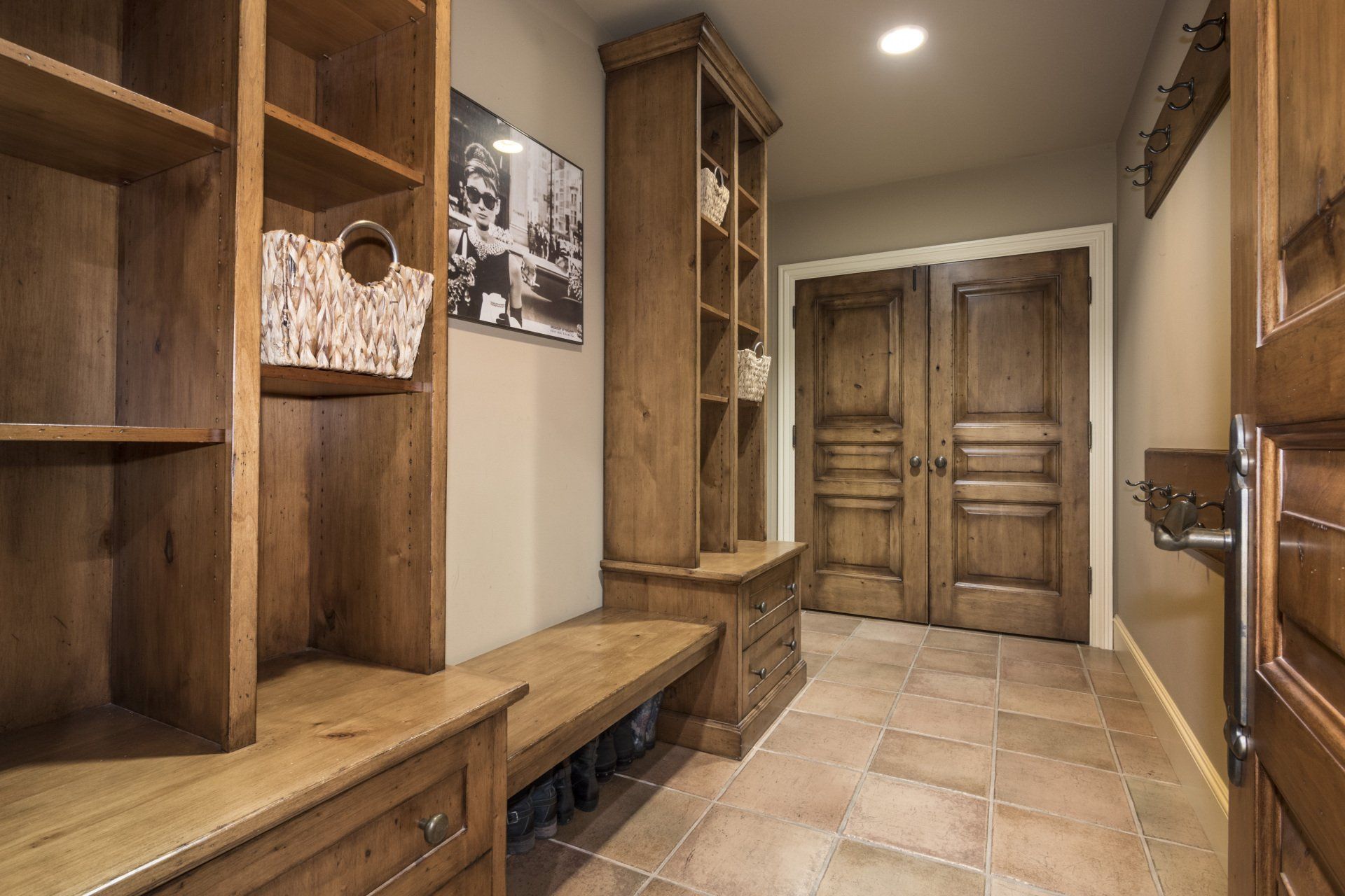 A hallway with wooden cabinets and a picture on the wall