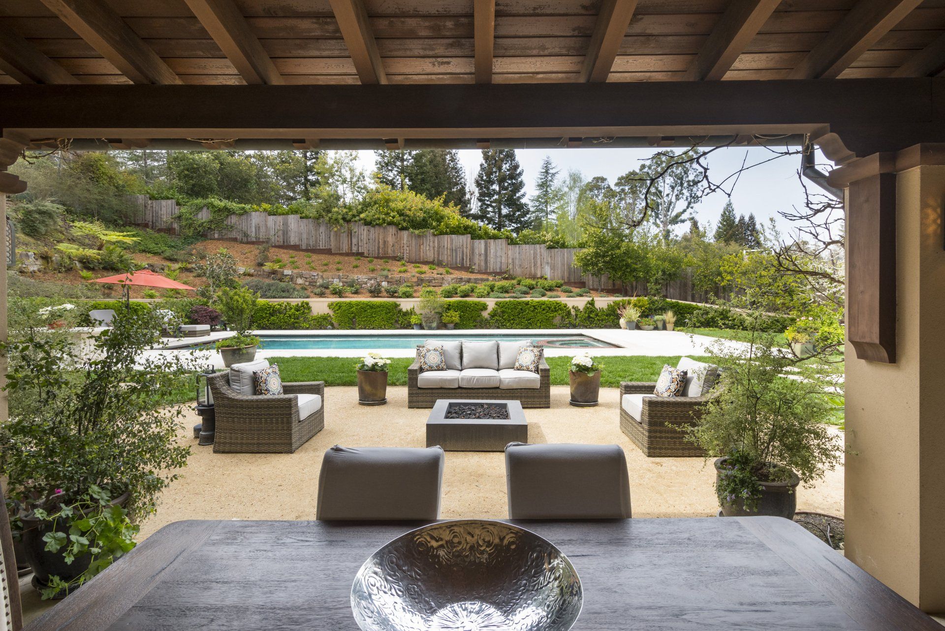 A patio with a table and chairs and a bowl on it