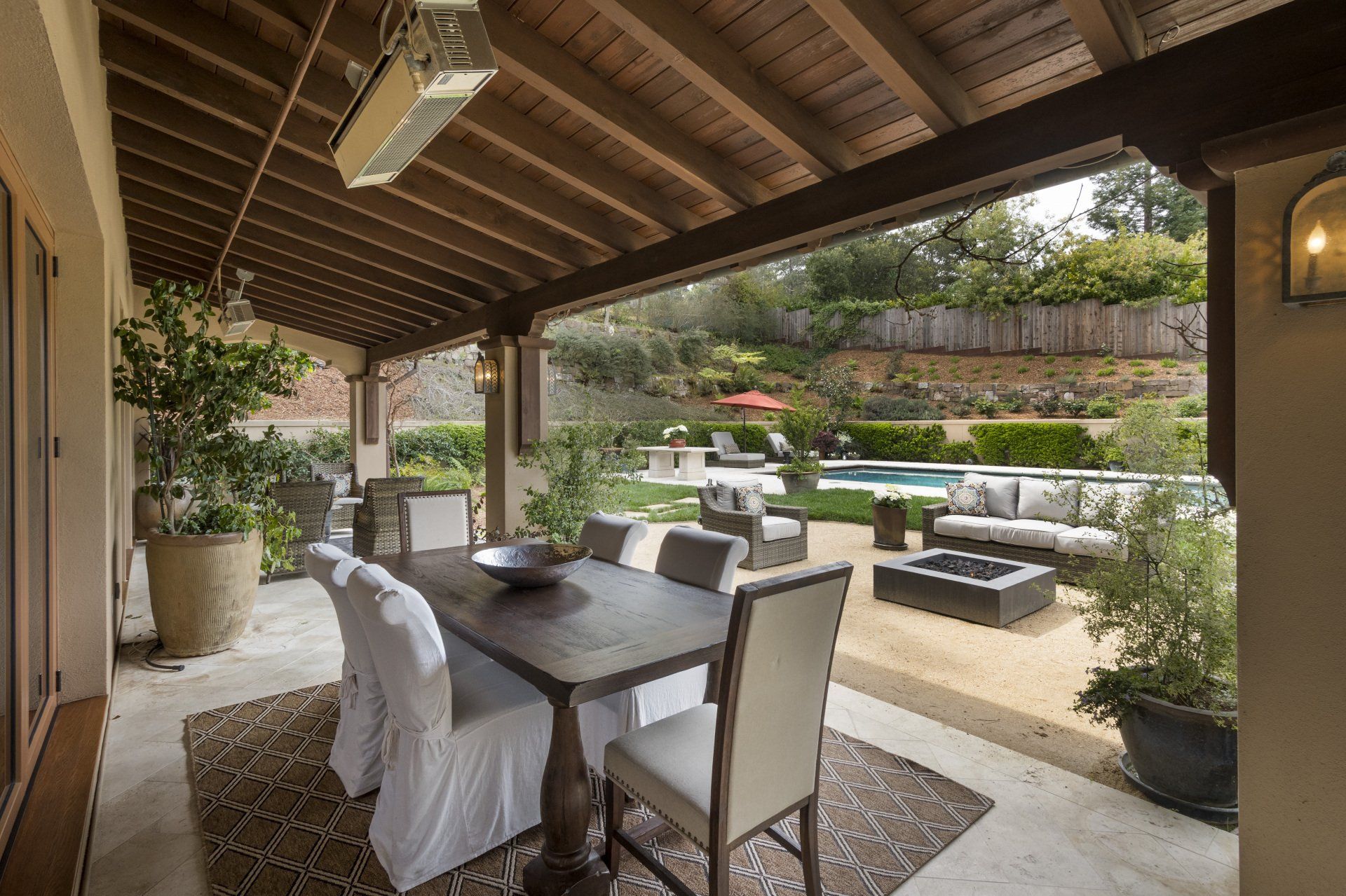 A patio with a table and chairs and a fire pit