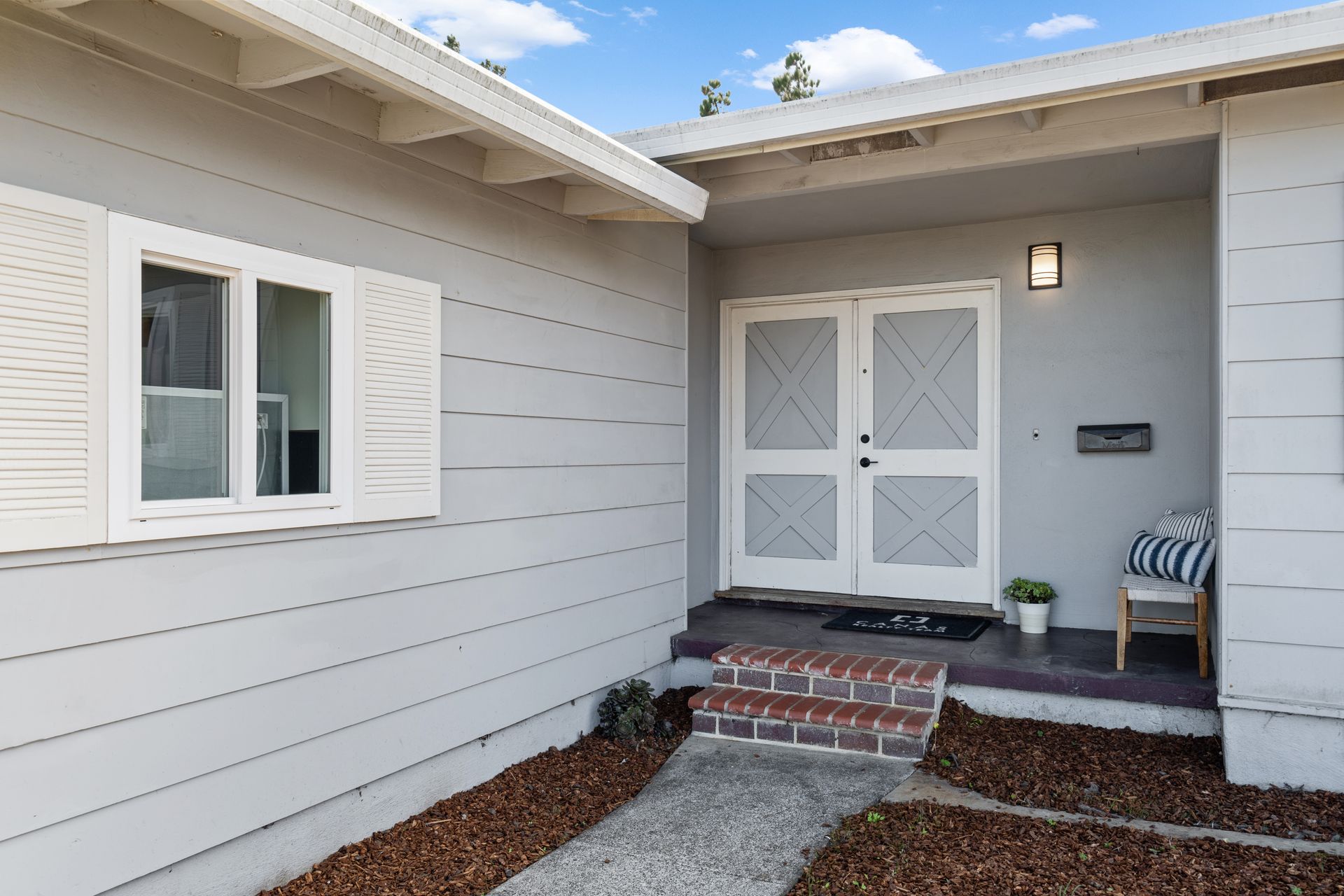 A house with a walkway leading to the front door.