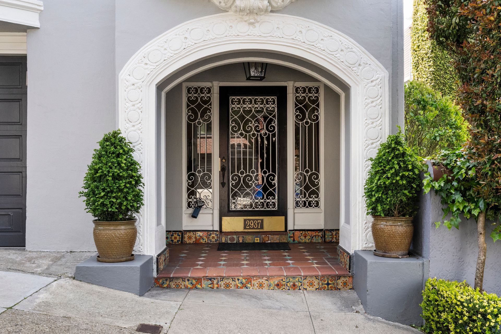 A house with a black door and a black garage door.