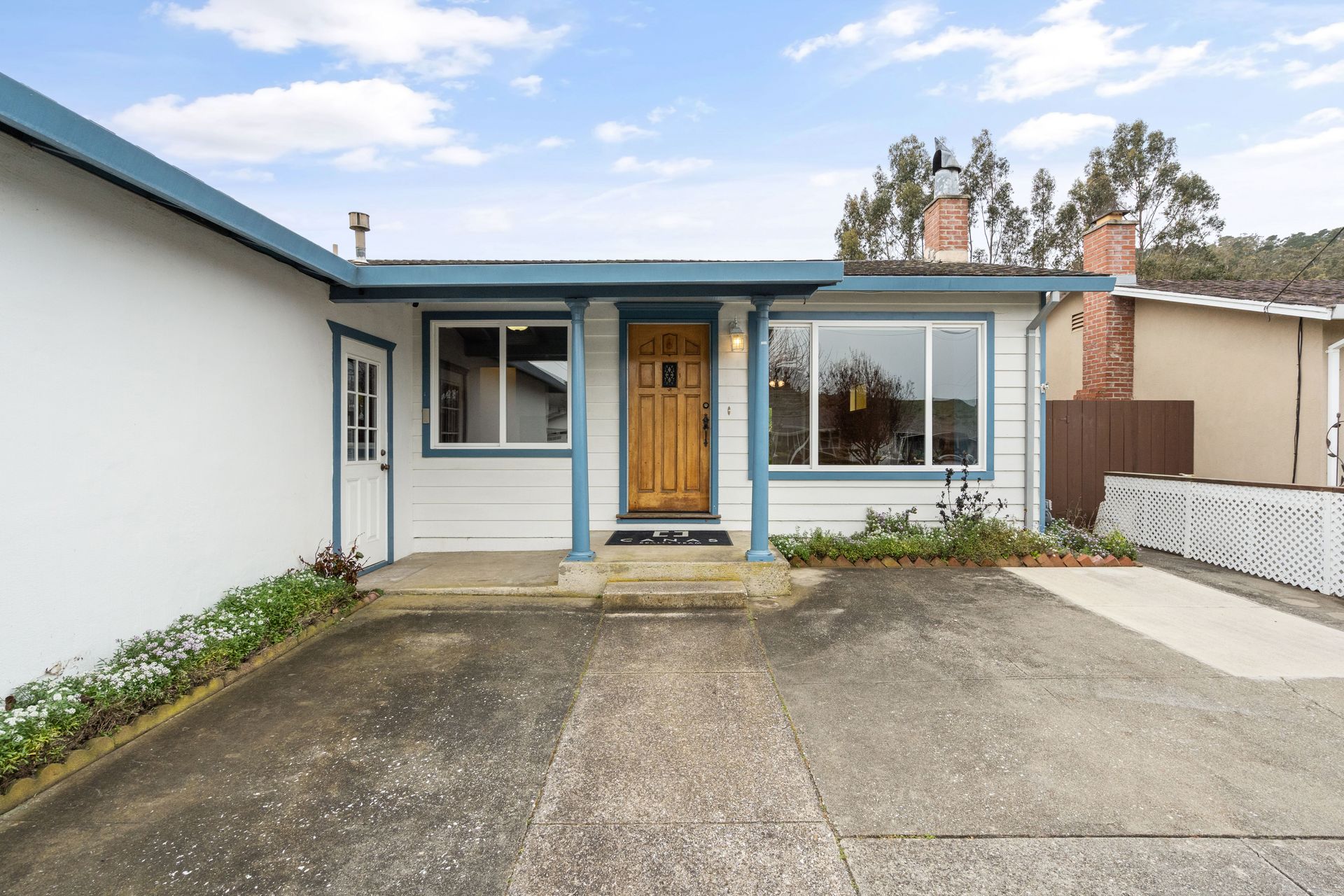 A white house with a blue roof.