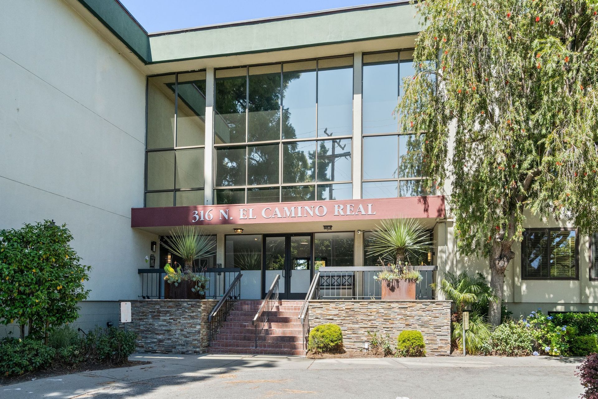 A large building with a staircase leading up to the entrance.