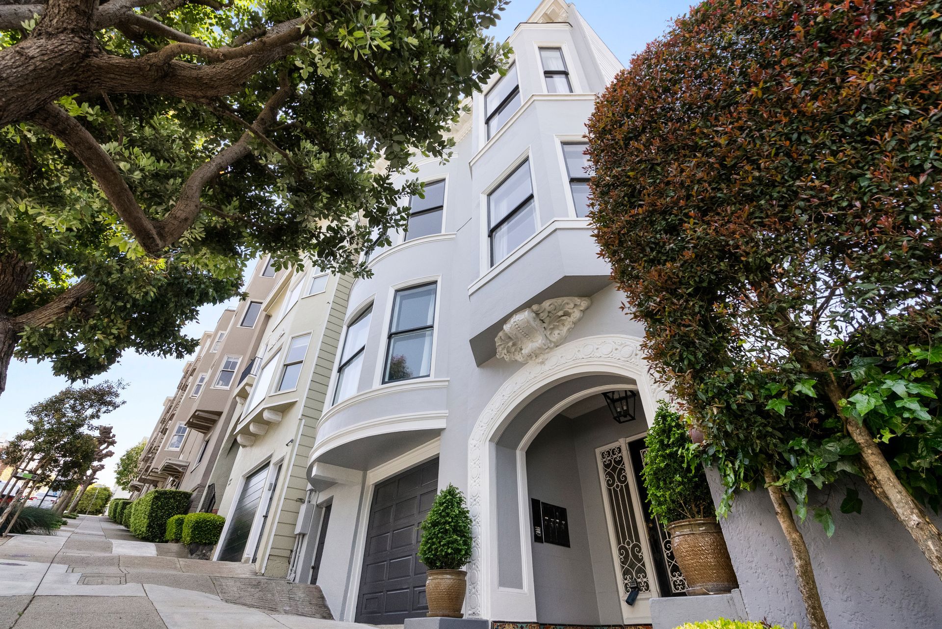 A building with a lot of windows and trees in front of it.