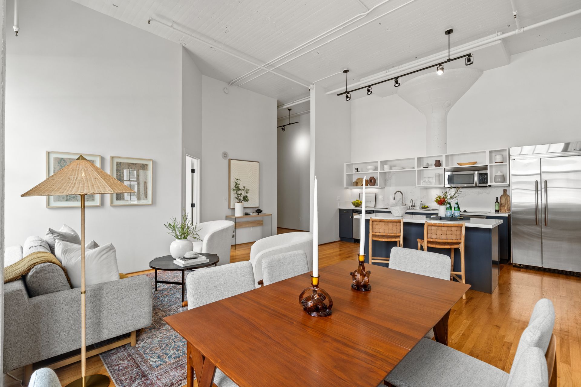 Bright, open loft apartment with living area, dining table, and modern kitchen.