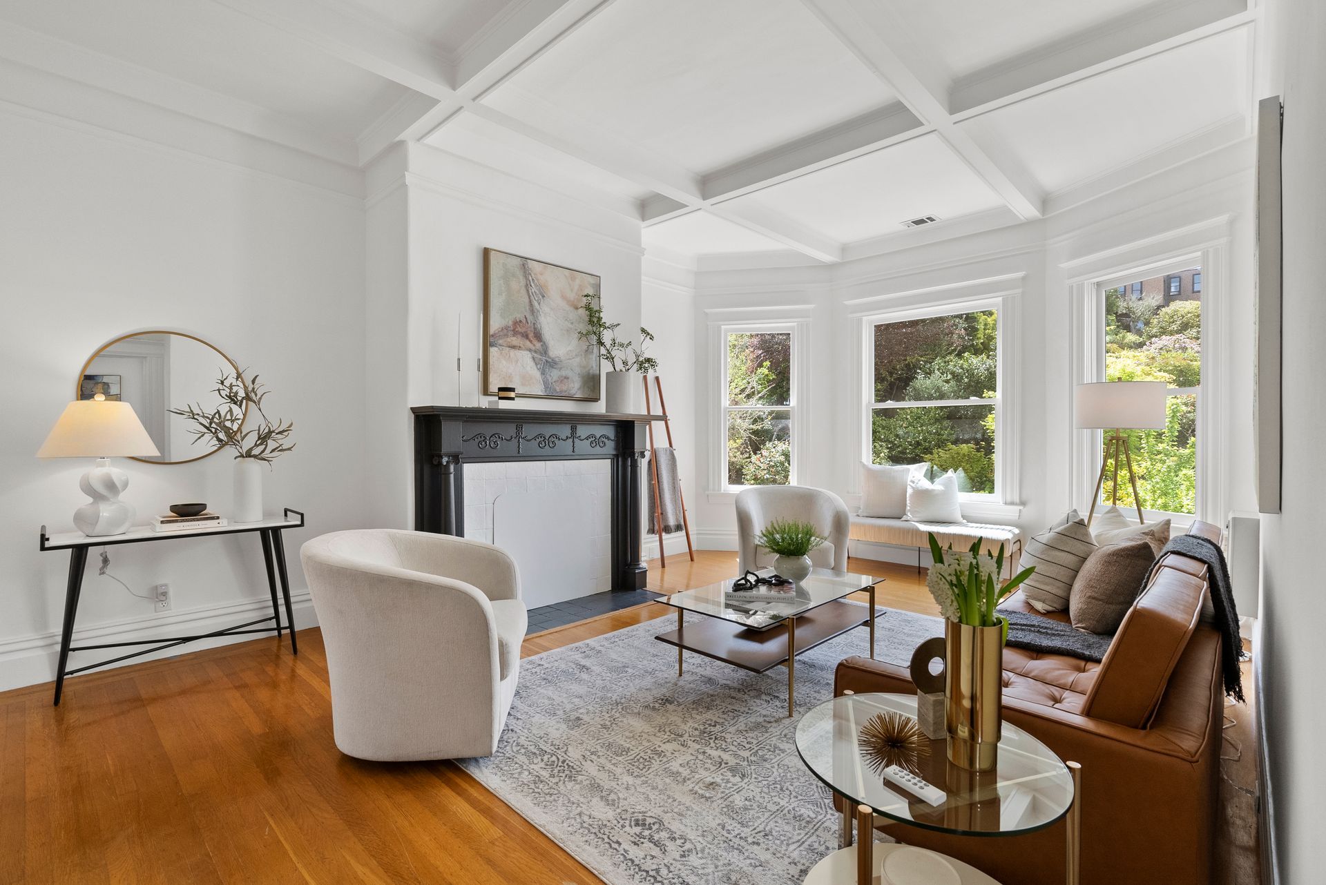 A living room with a couch , chair , coffee table and fireplace.