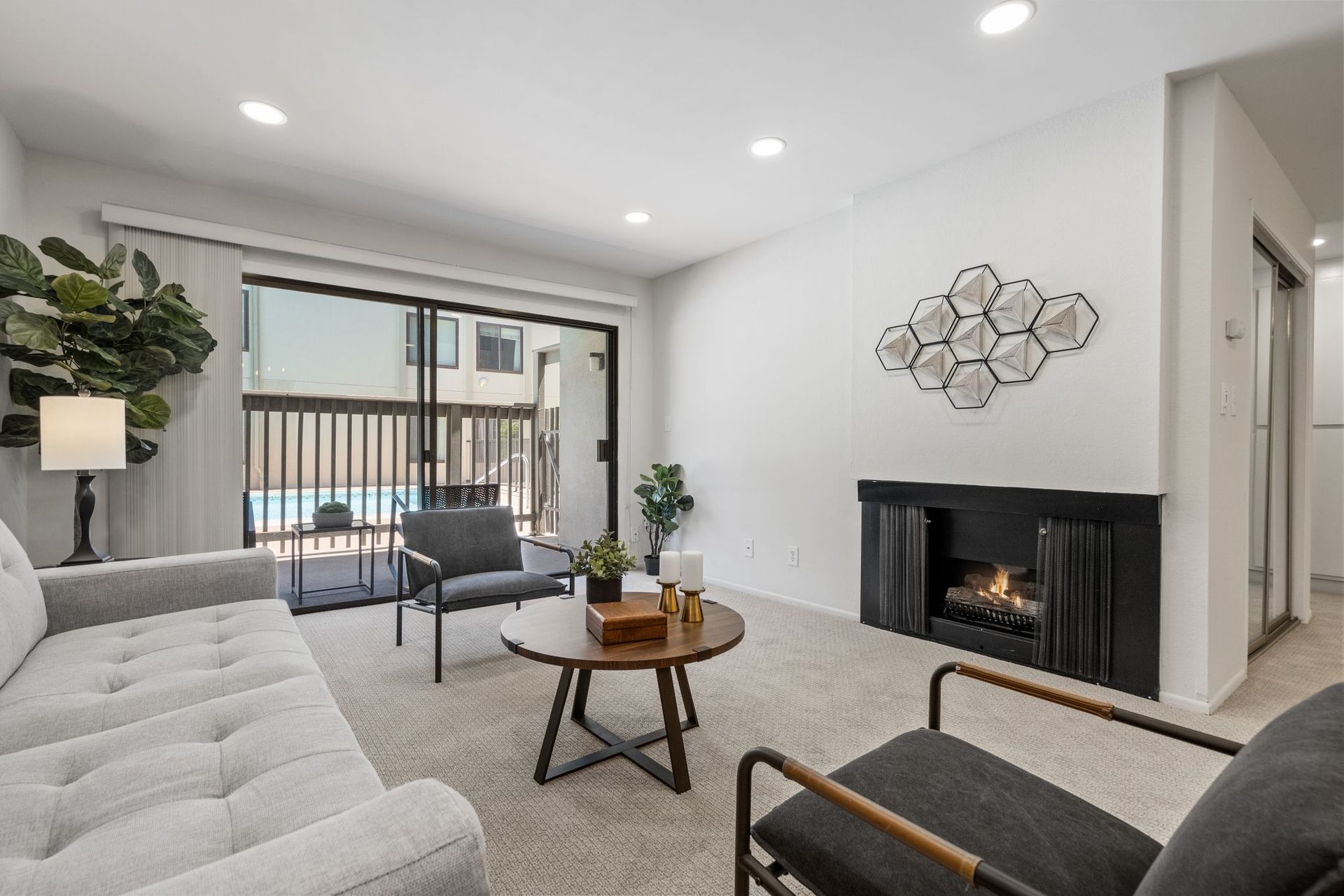 A living room with a fireplace and sliding glass doors.