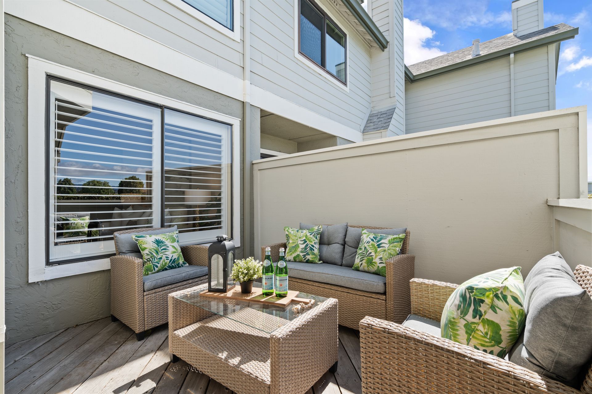 A patio with a couch and chairs and a table