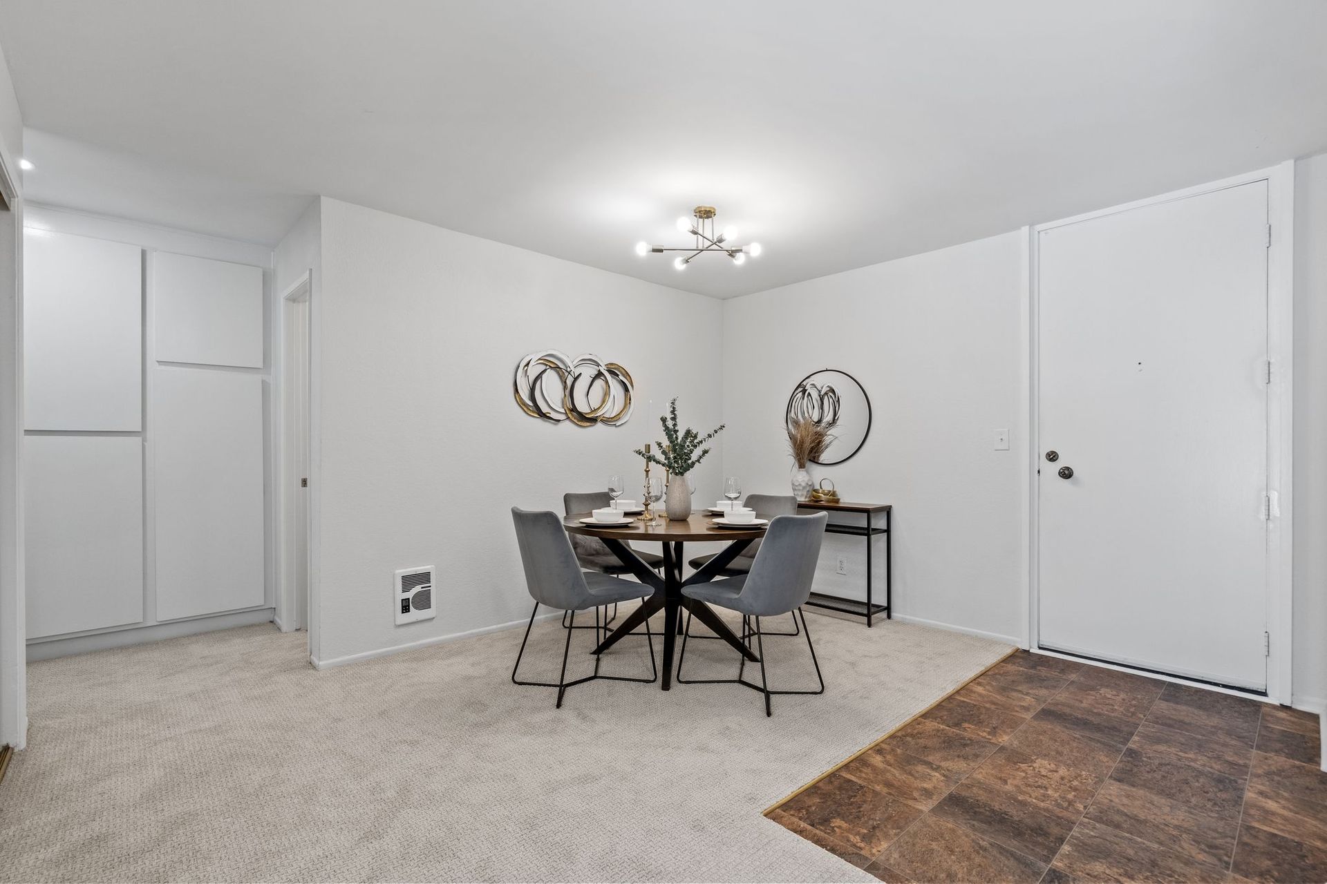 A room with a dining table and chairs in it