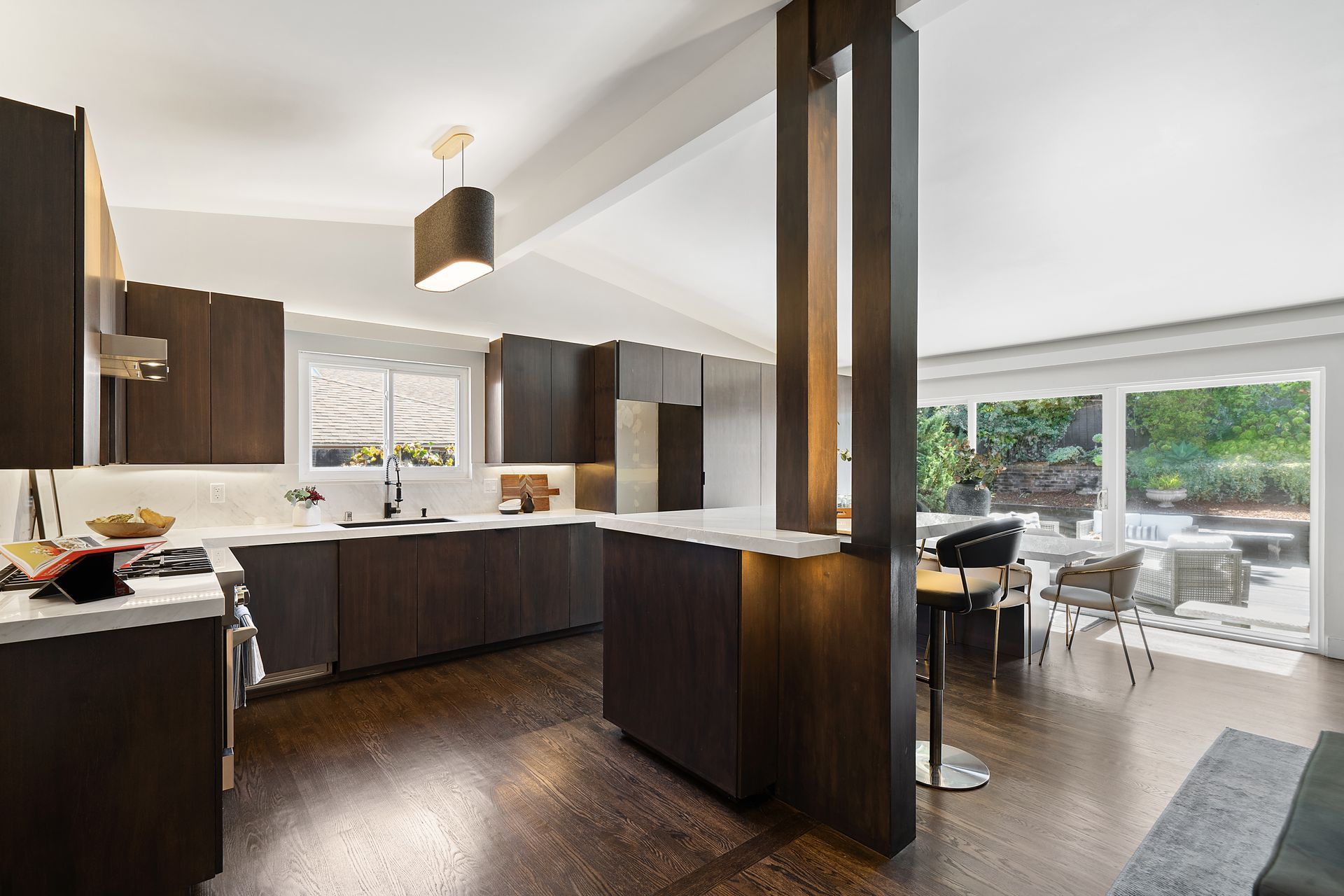 A kitchen with dark wood cabinets and stainless steel appliances.