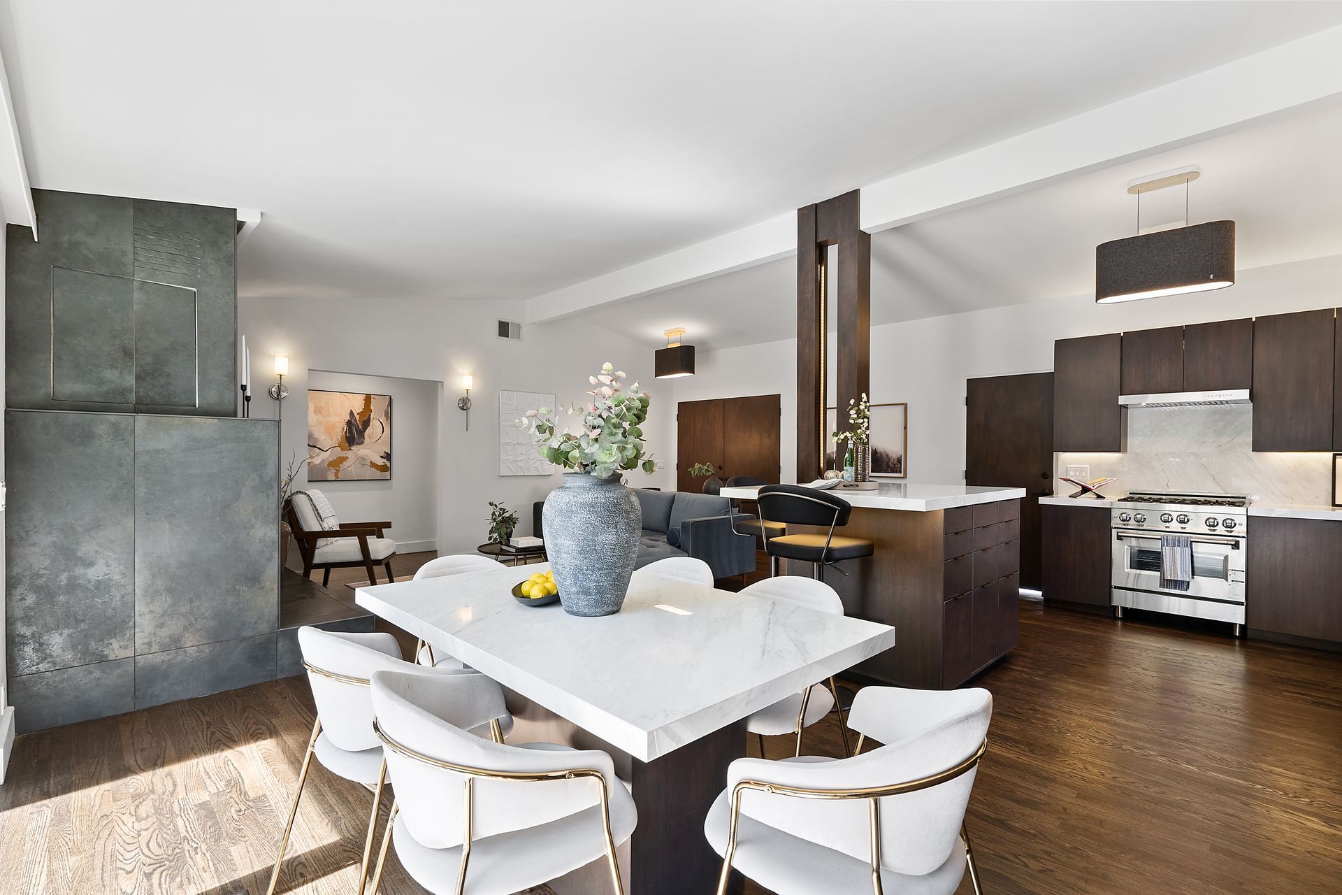 A living room with a dining table and chairs.