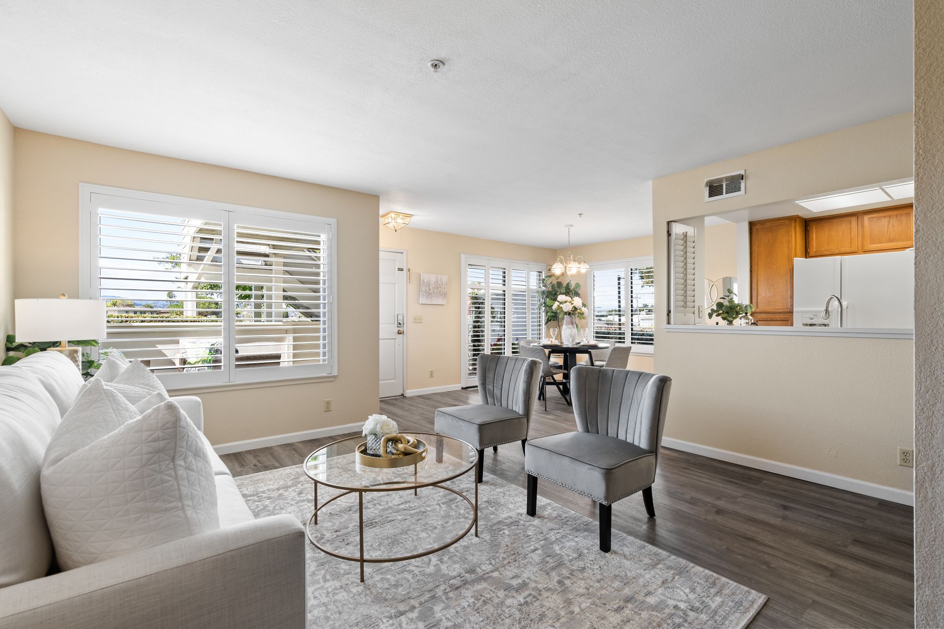 A living room with a couch , chairs , and a coffee table.
