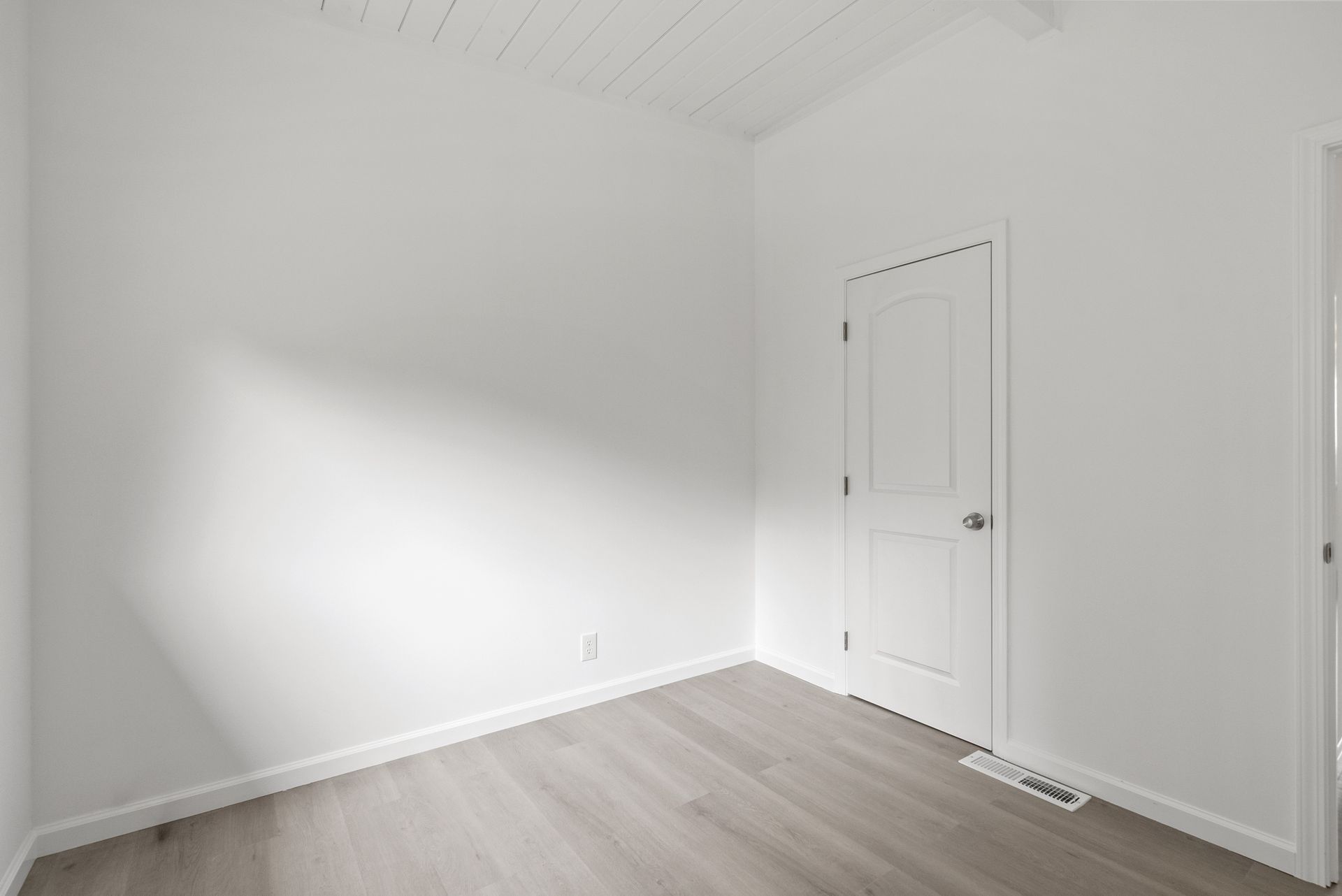 There is a door in the corner of the room.