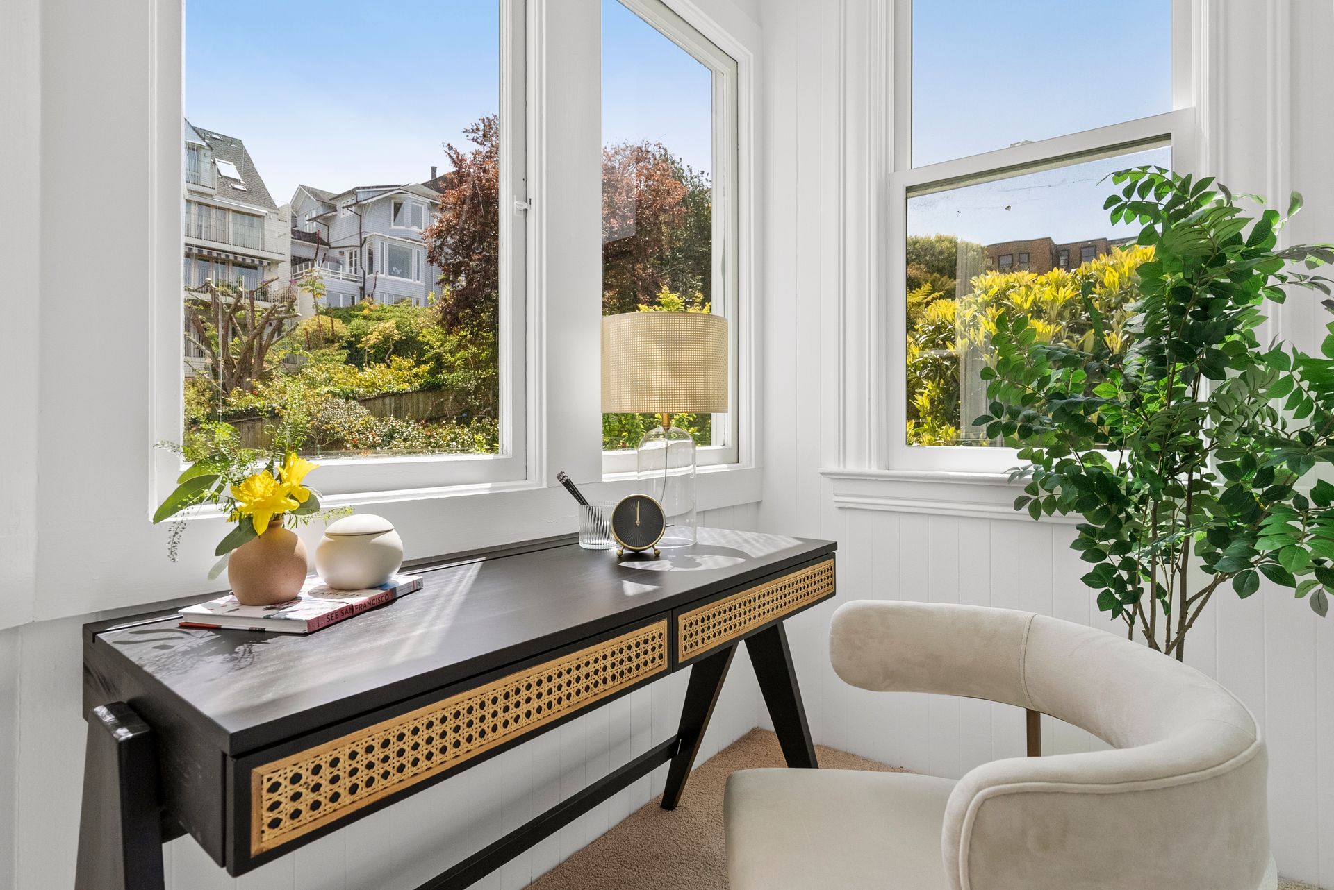 A home office with a desk and chair in front of a window.
