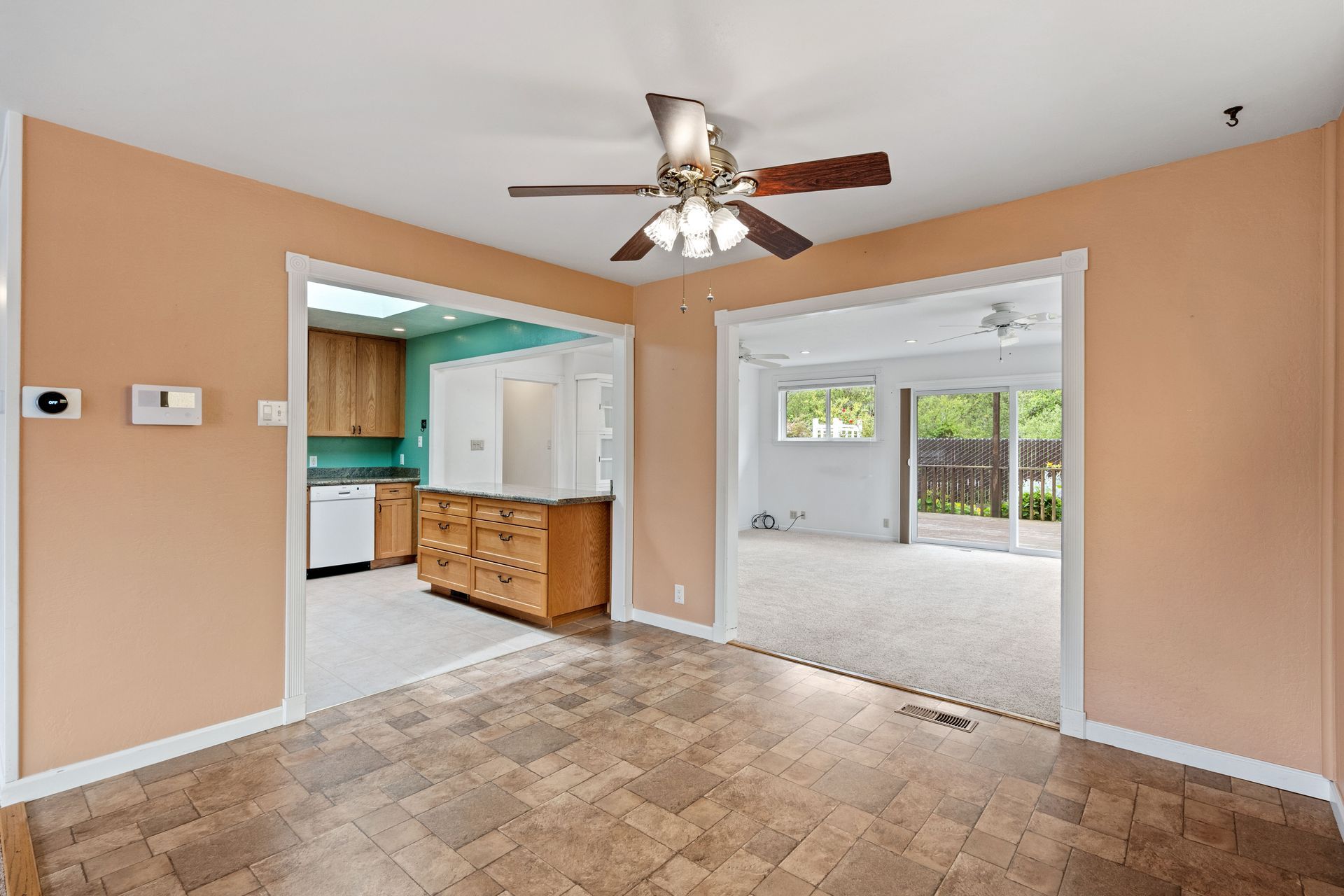An empty room with a ceiling fan in it.