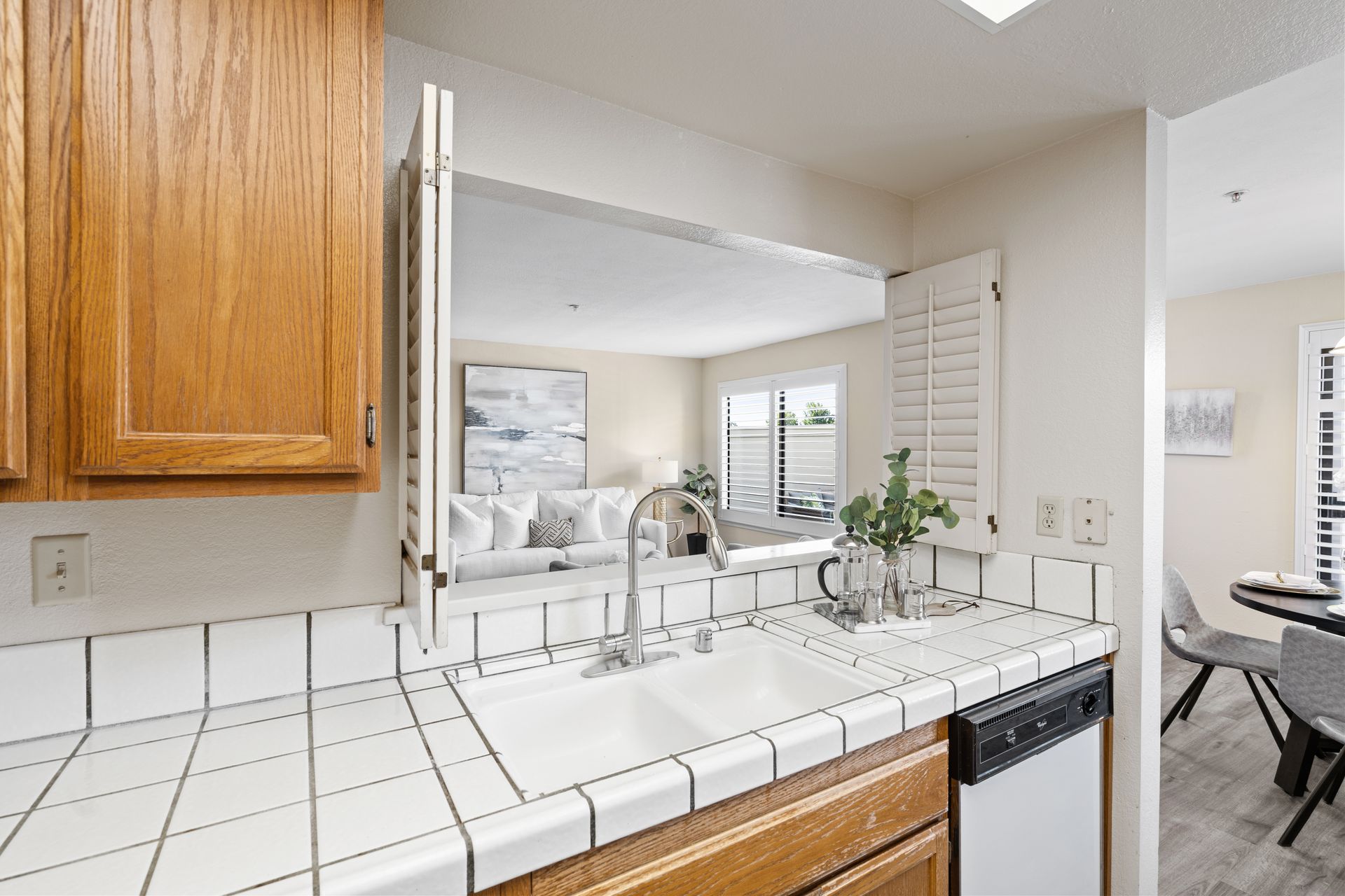 A kitchen with a sink , dishwasher , and microwave.