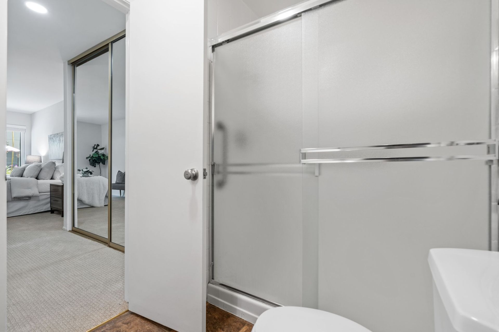 A bathroom with a toilet , sink and shower stall.