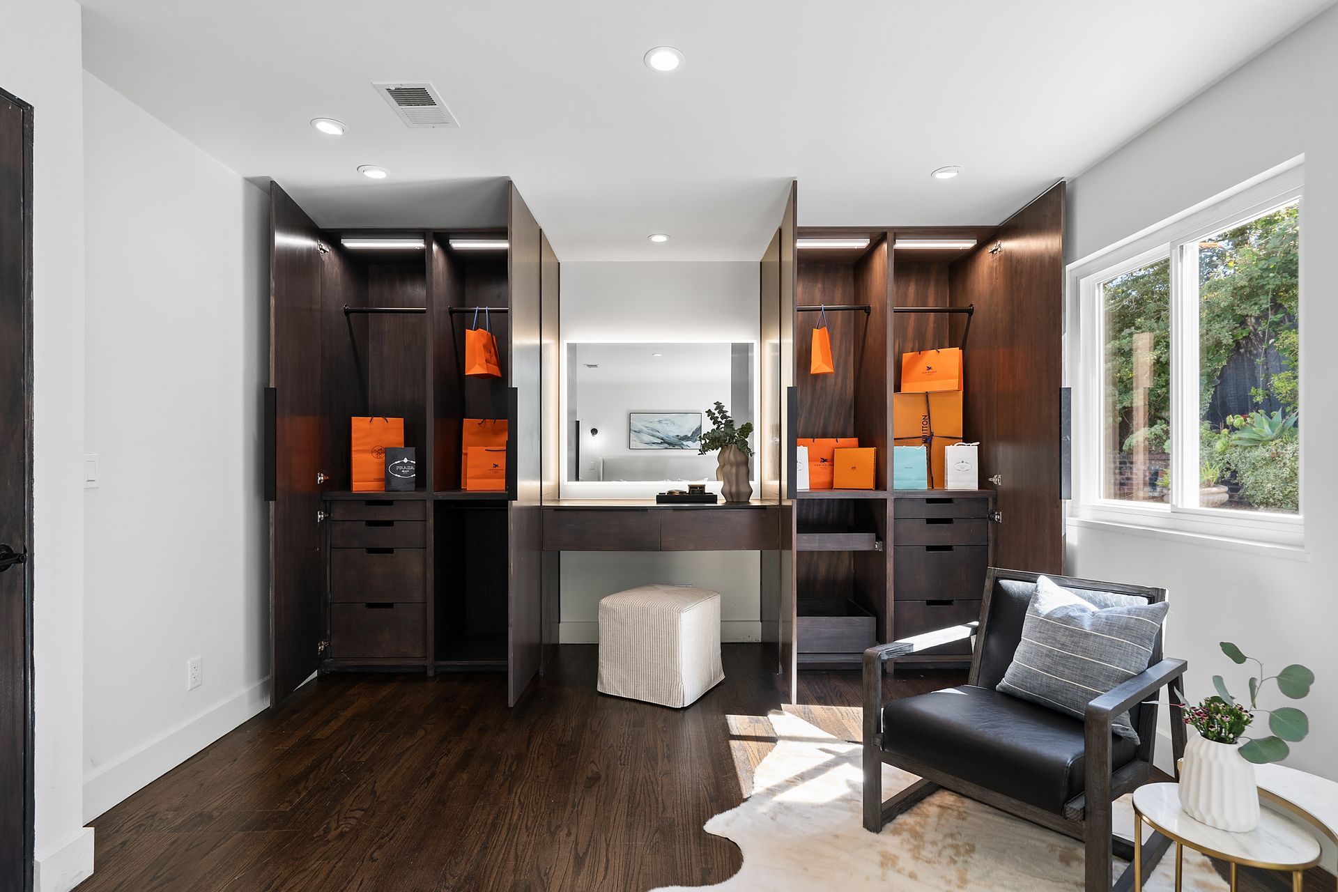 Two closets with a chair and a dresser in a room.