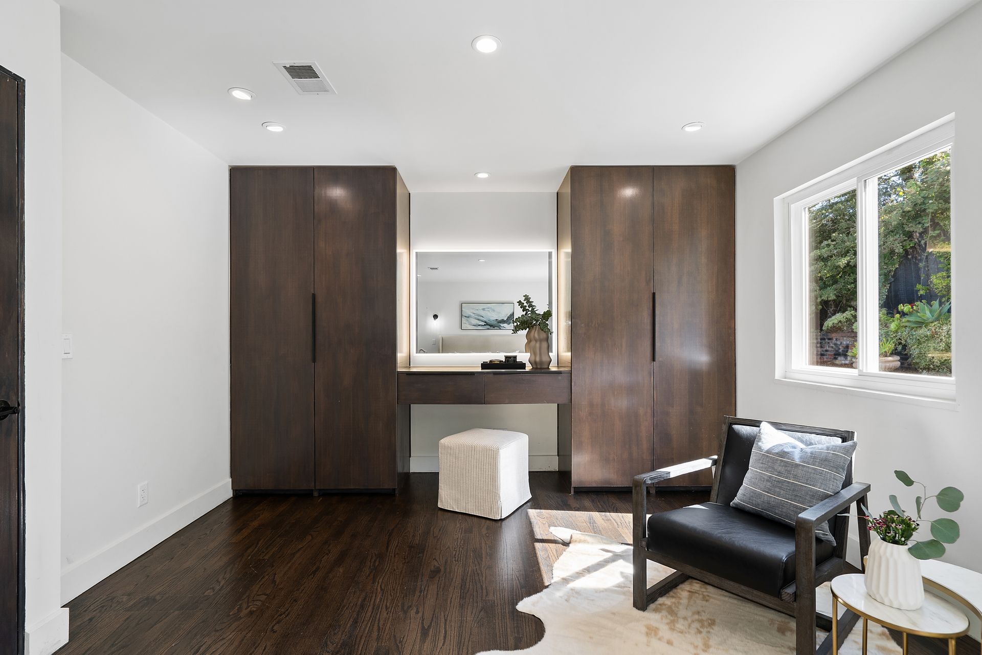 A room with a chair and a dresser.