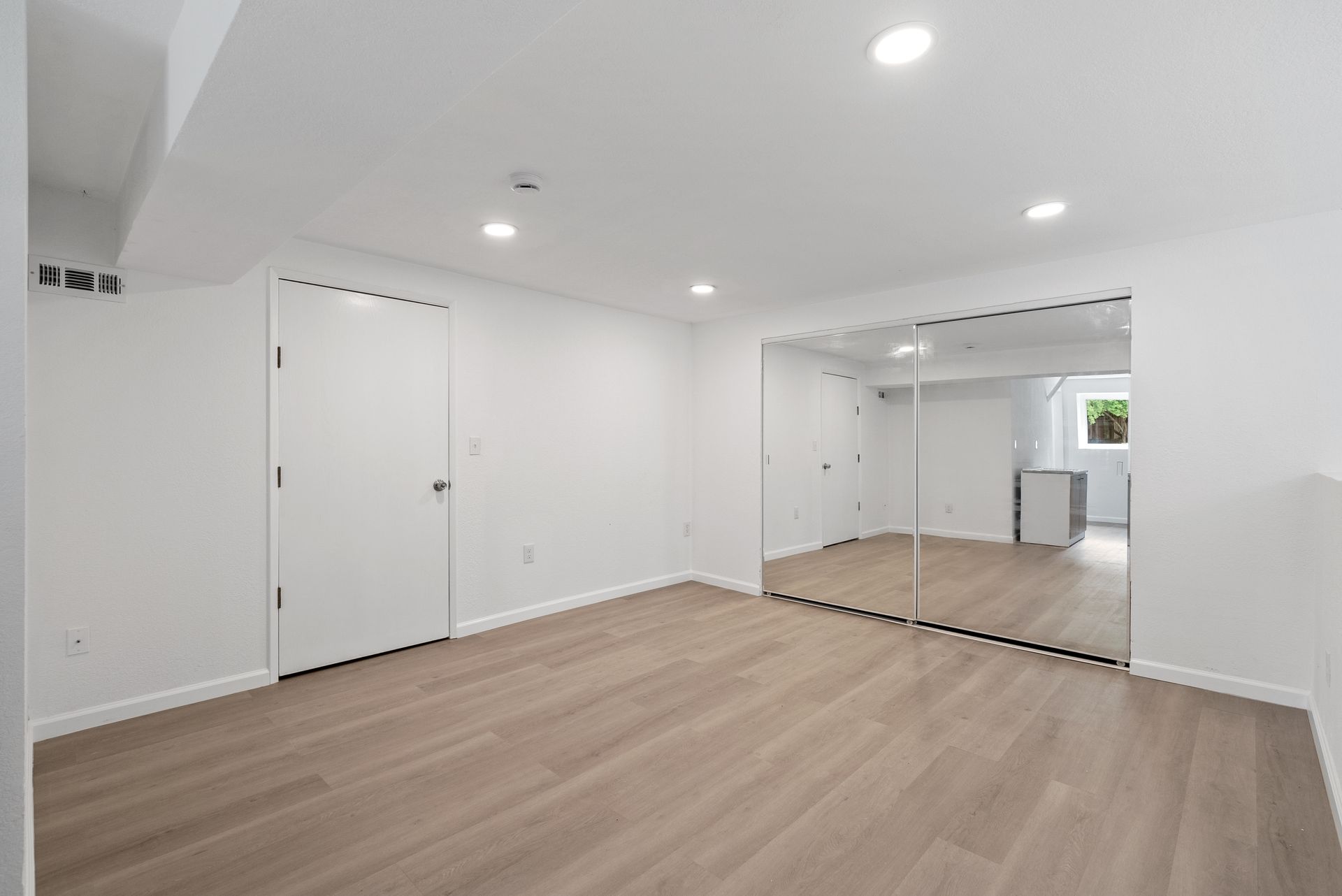 A room has a mirrored closet.