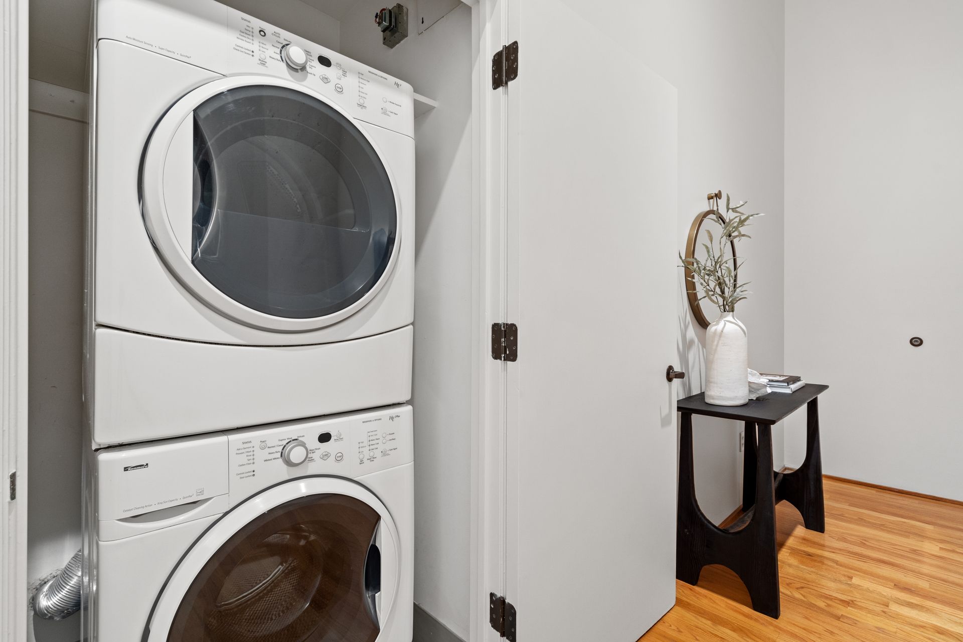 A washer and dryer are stacked on top of each other in a laundry room.