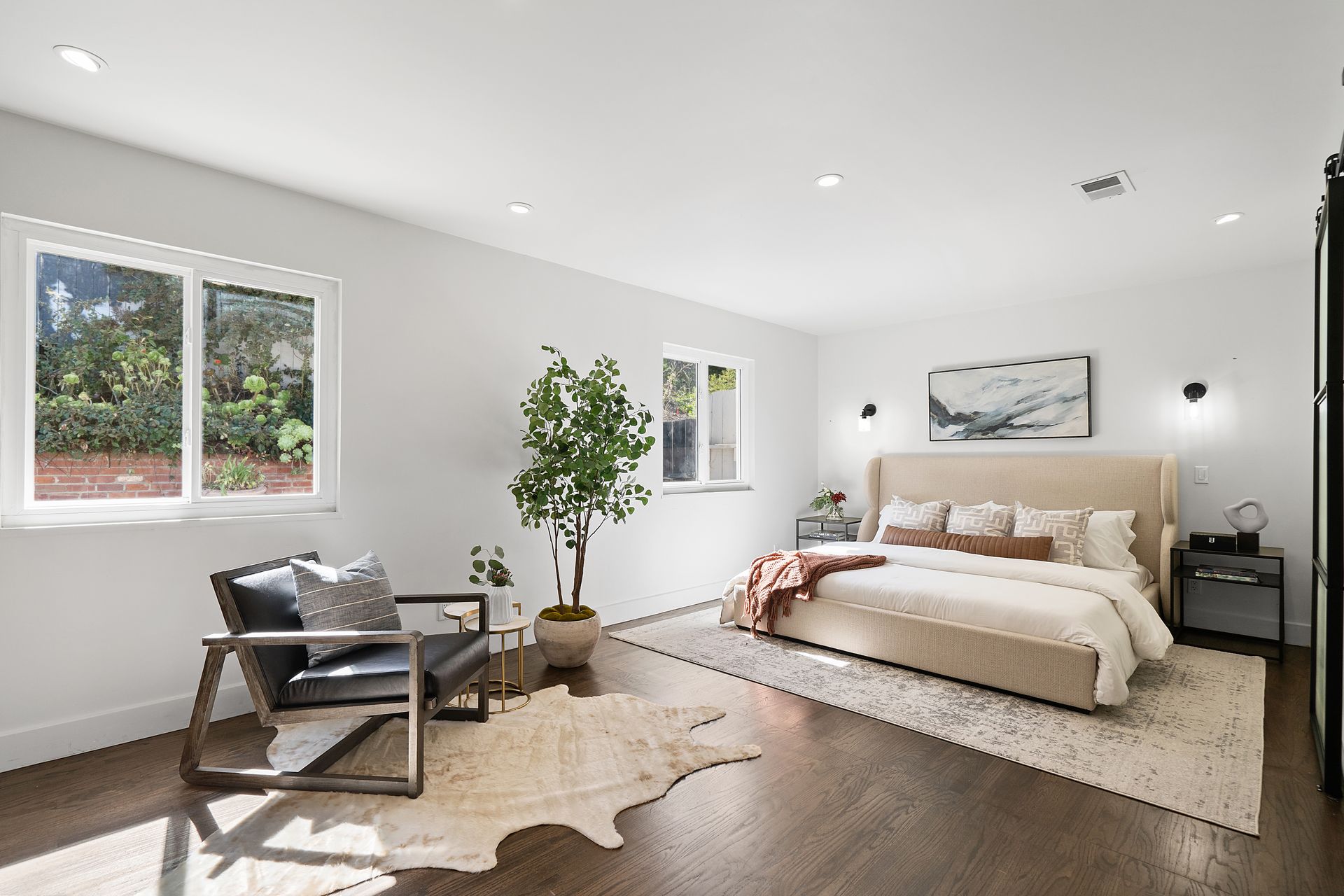 A bedroom with a bed and a chair.