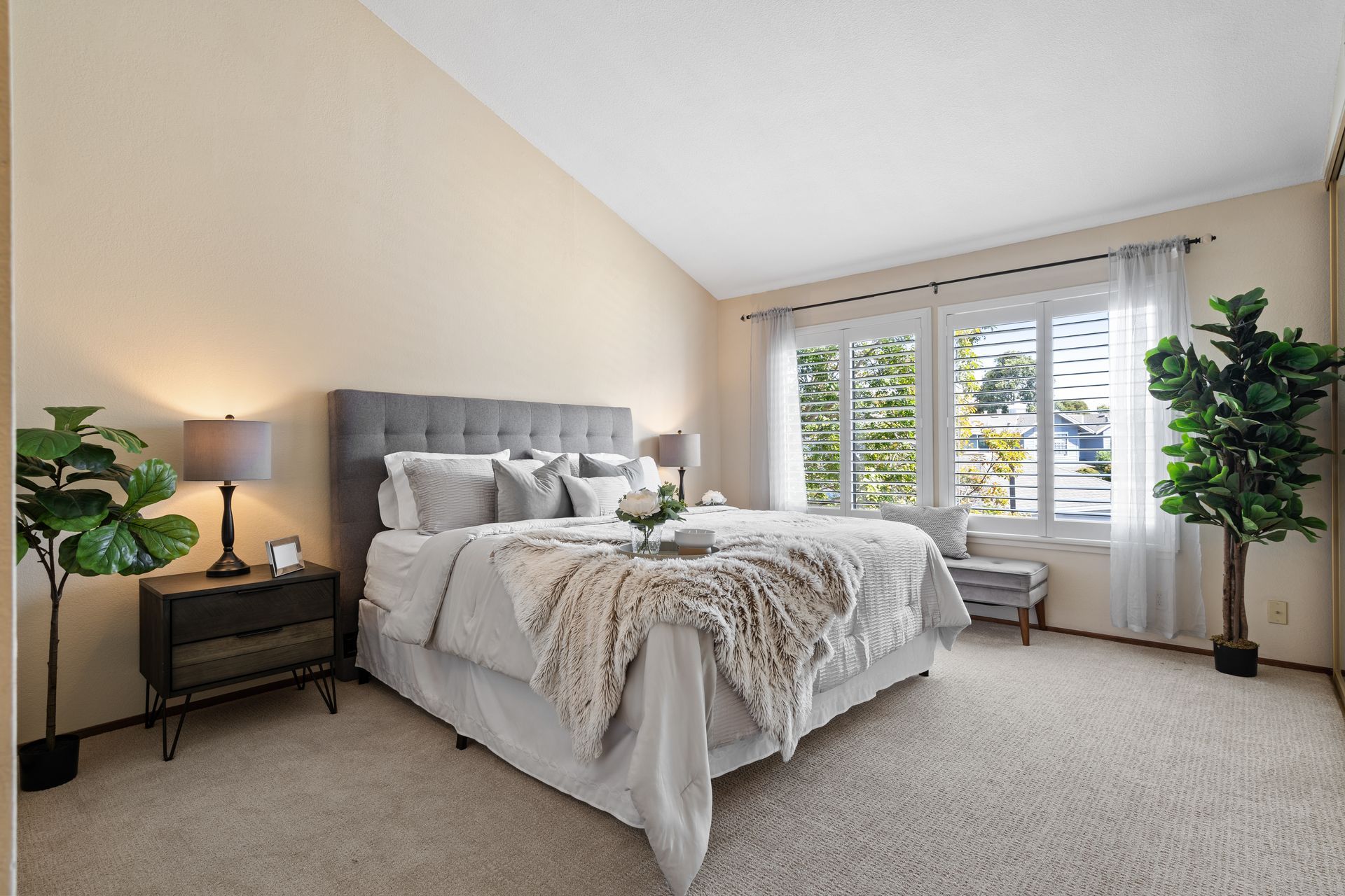 A bedroom with a king size bed and a nightstand