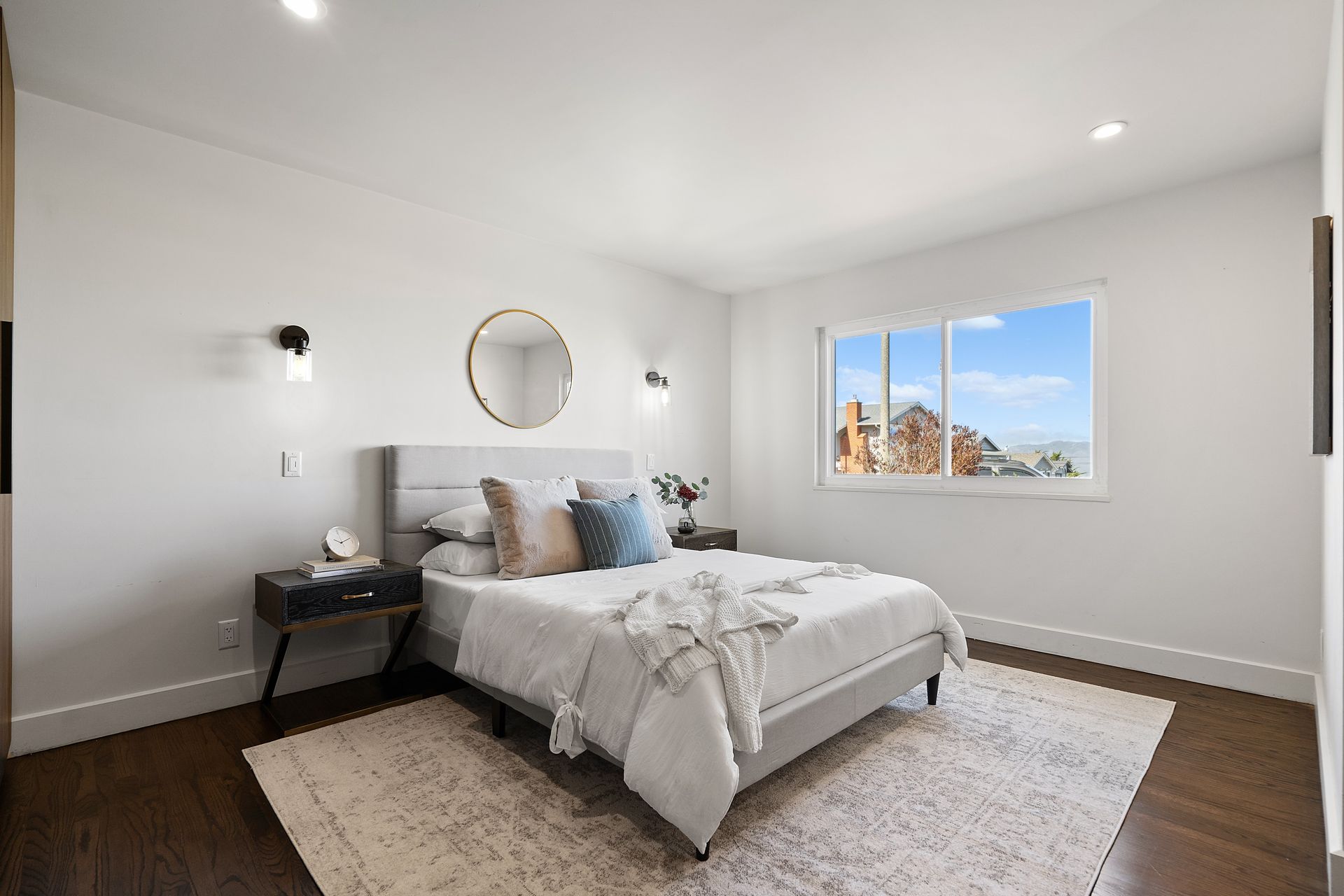 A bedroom with a bed and a window.
