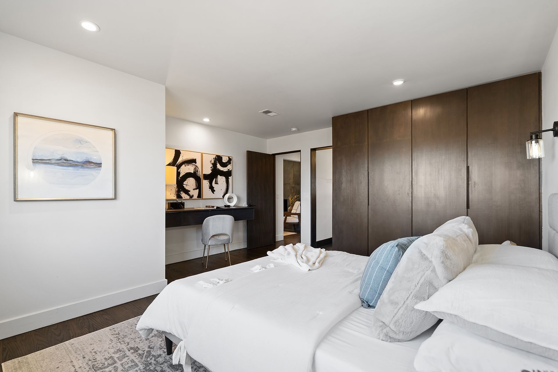 A bedroom with a bed and a picture on the wall