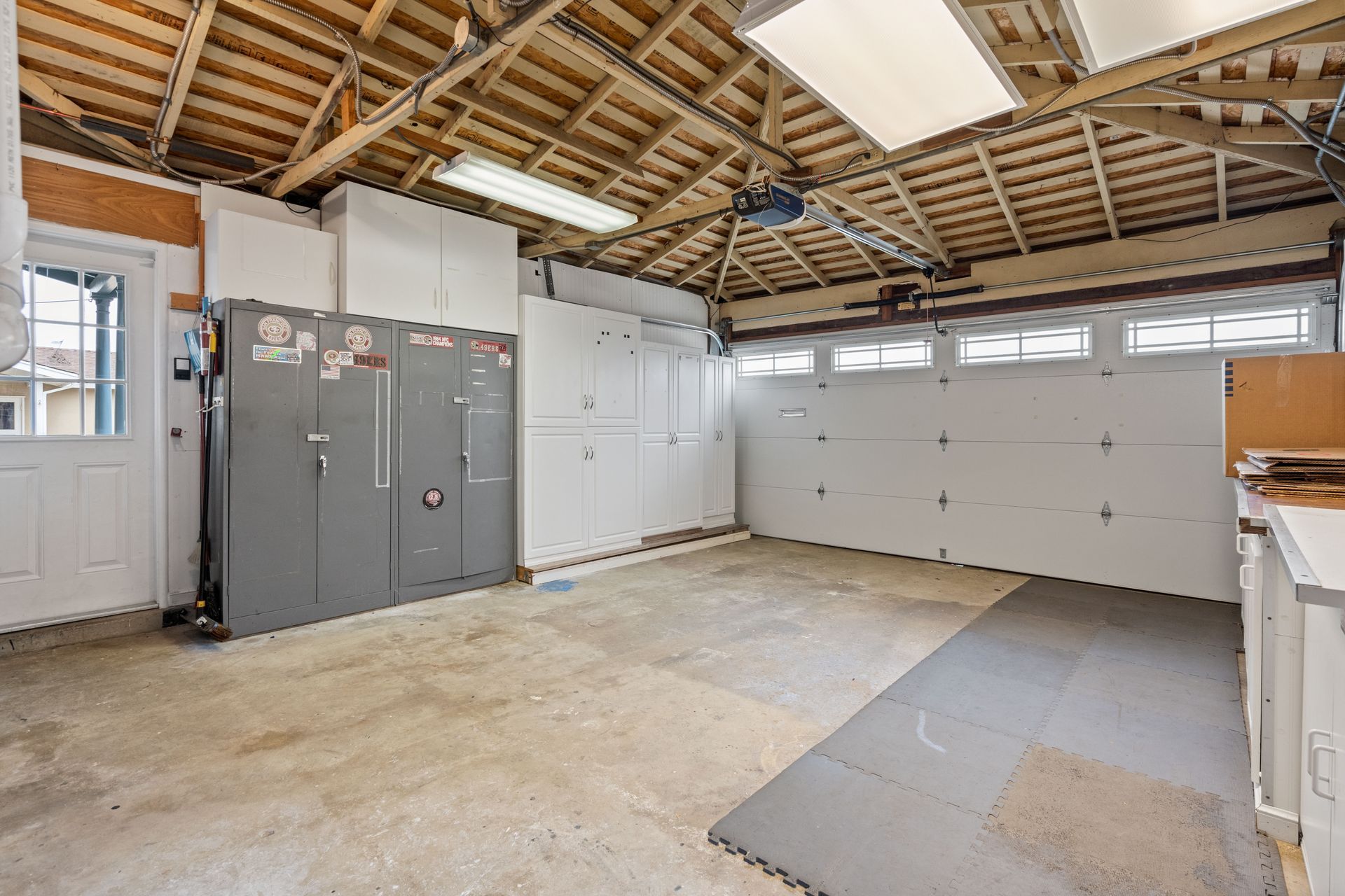 An empty garage with a garage door closed