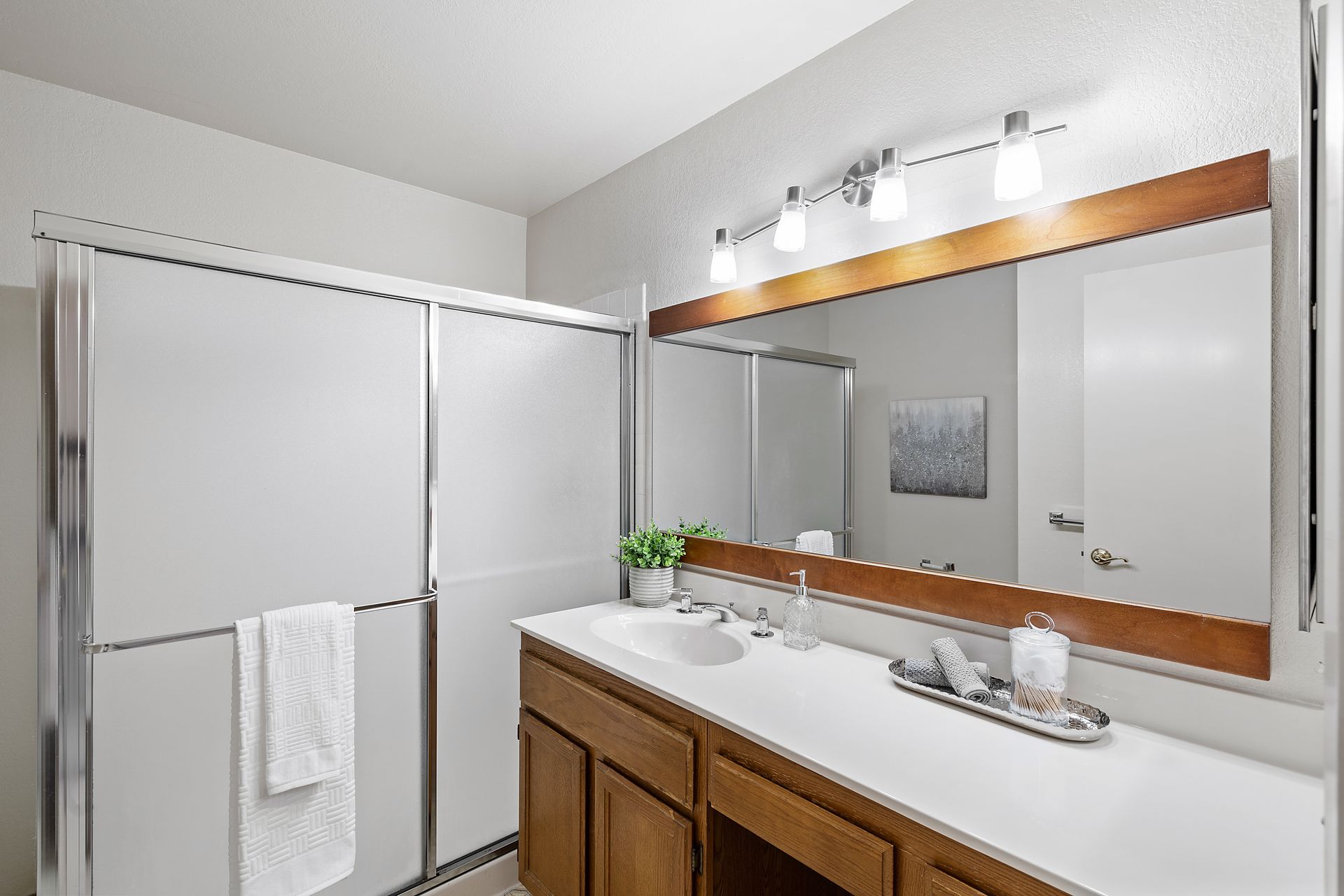 A bathroom with a sink and a large mirror