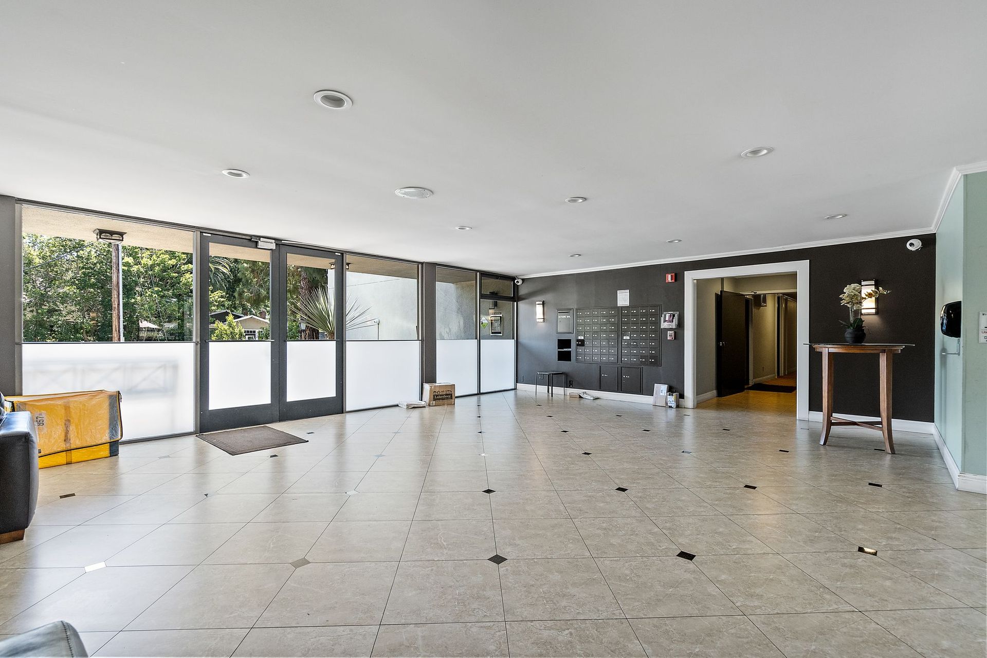 A large room with a lot of windows and tile floors.