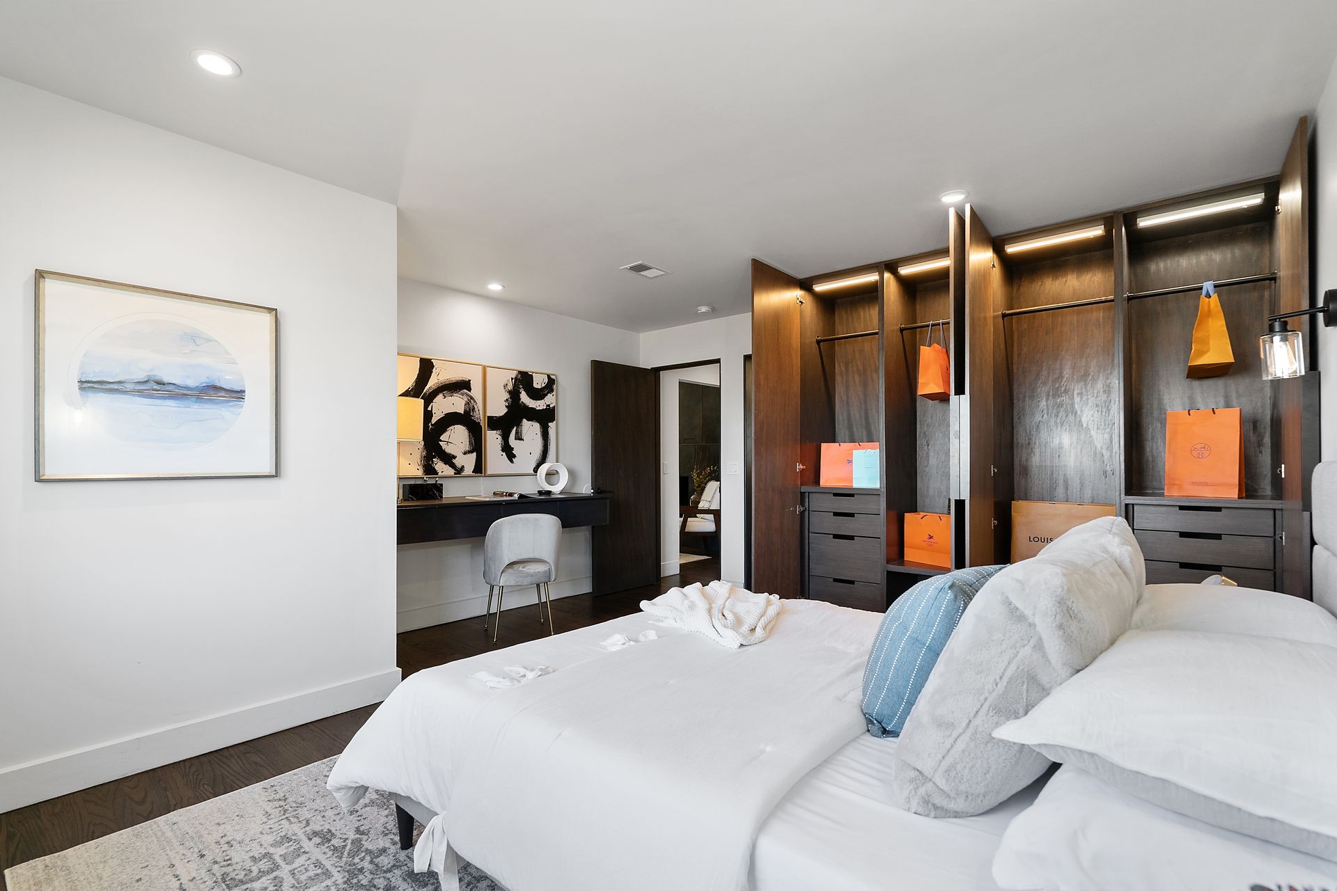 A bedroom with a bed and a painting on the wall.