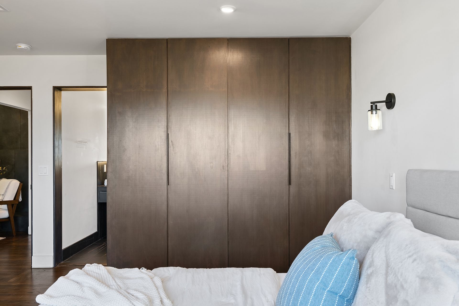 A bedroom with a bed and a wardrobe.