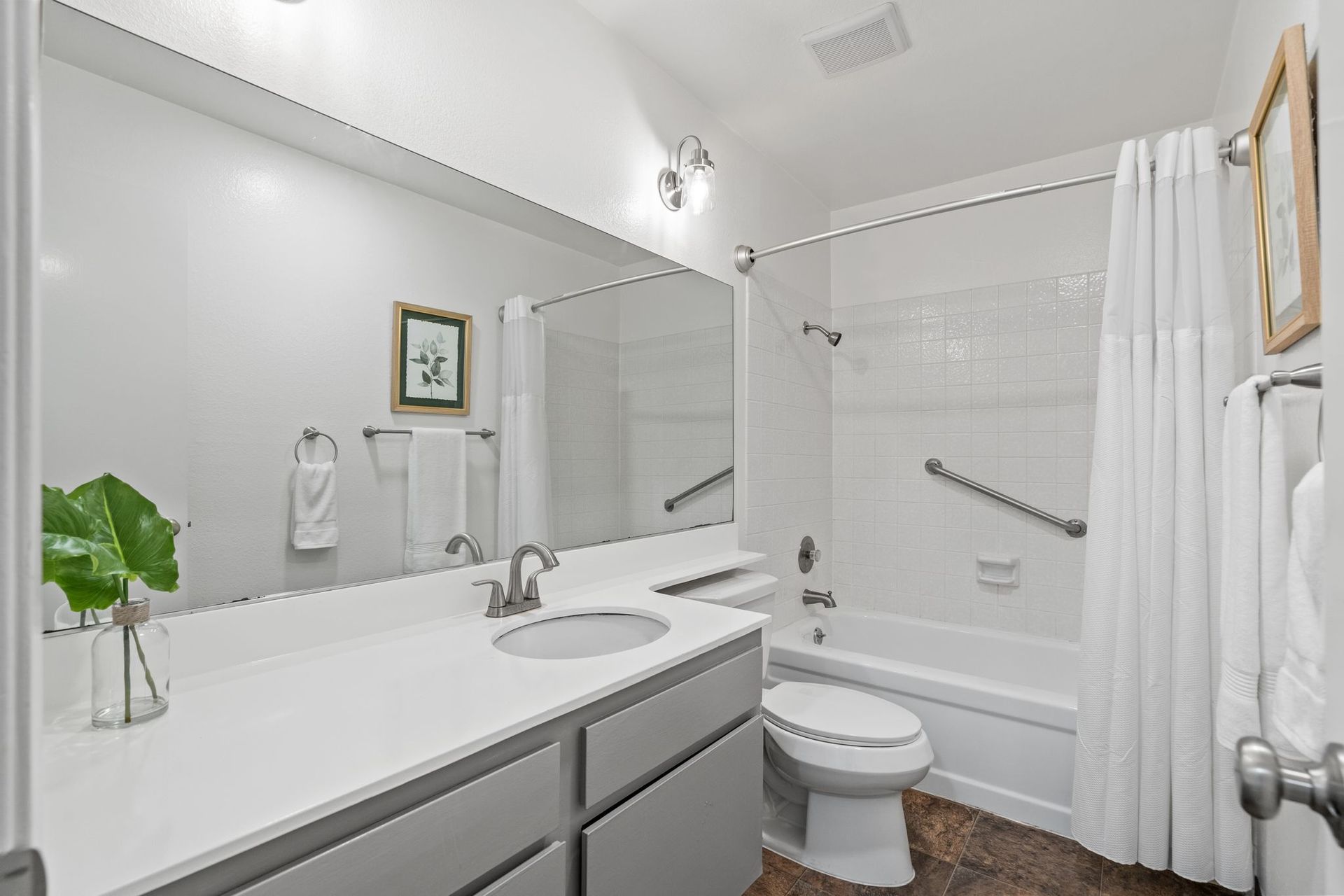 A bathroom with a toilet , sink , and shower.