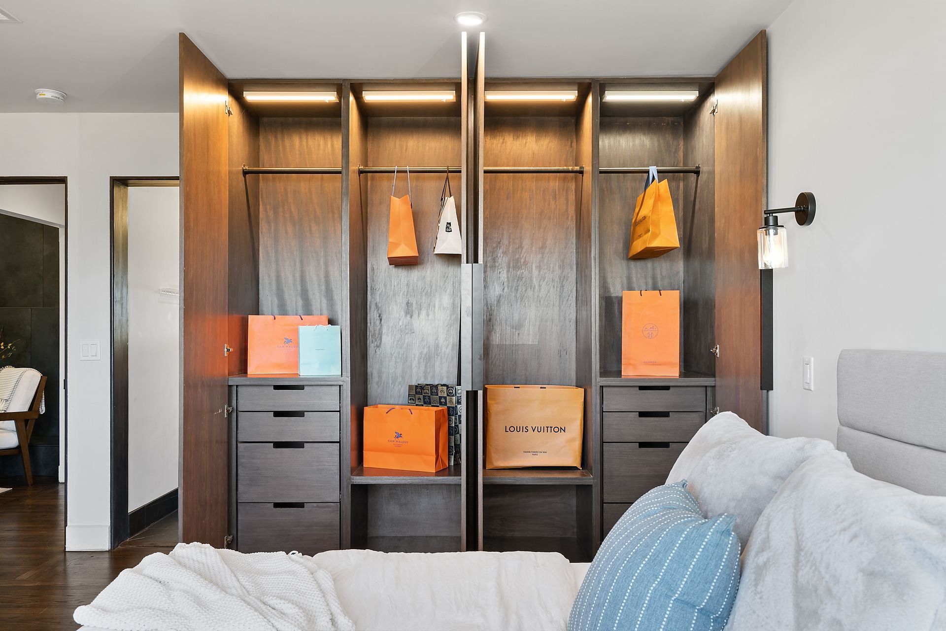 A bedroom with a closet and a bed.