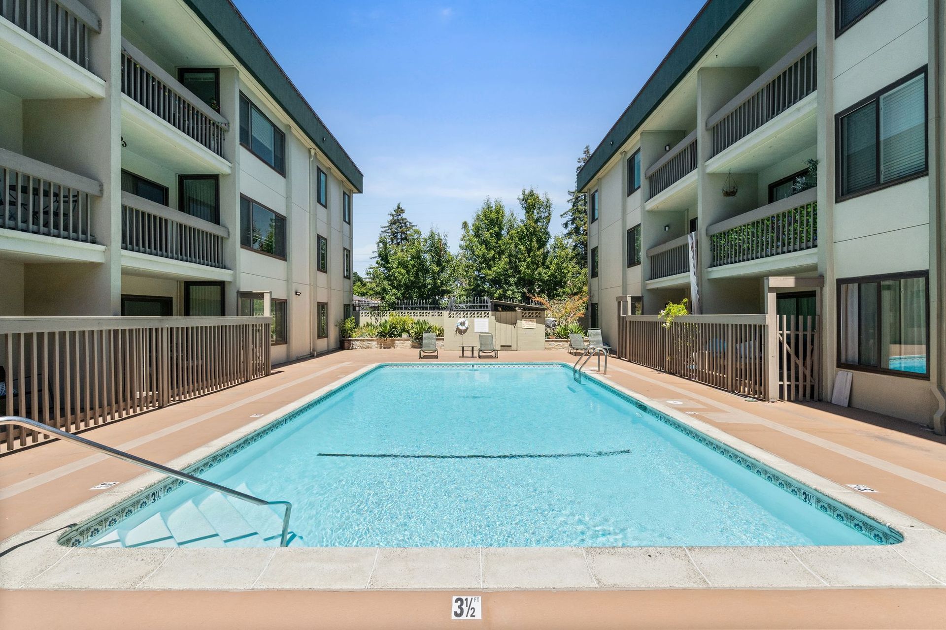 A large swimming pool in front of a building.