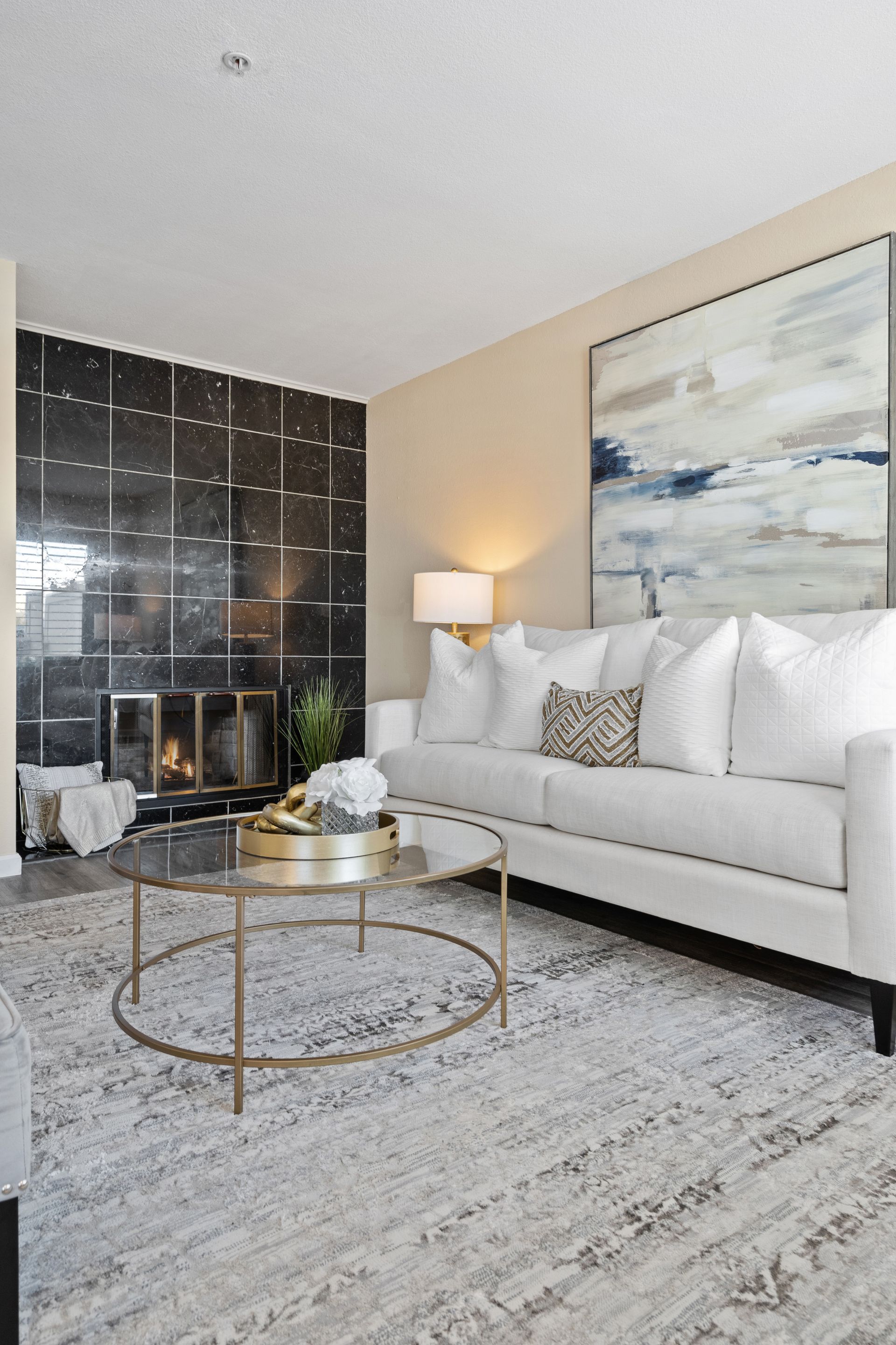 A living room with a white couch and a coffee table