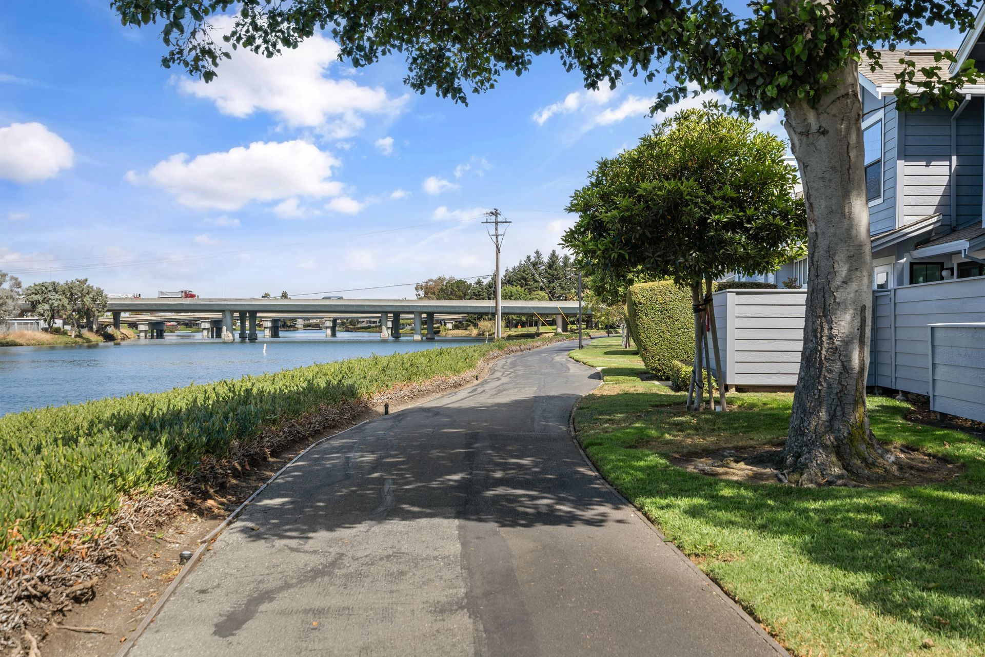 A road leading to a bridge over a body of water.