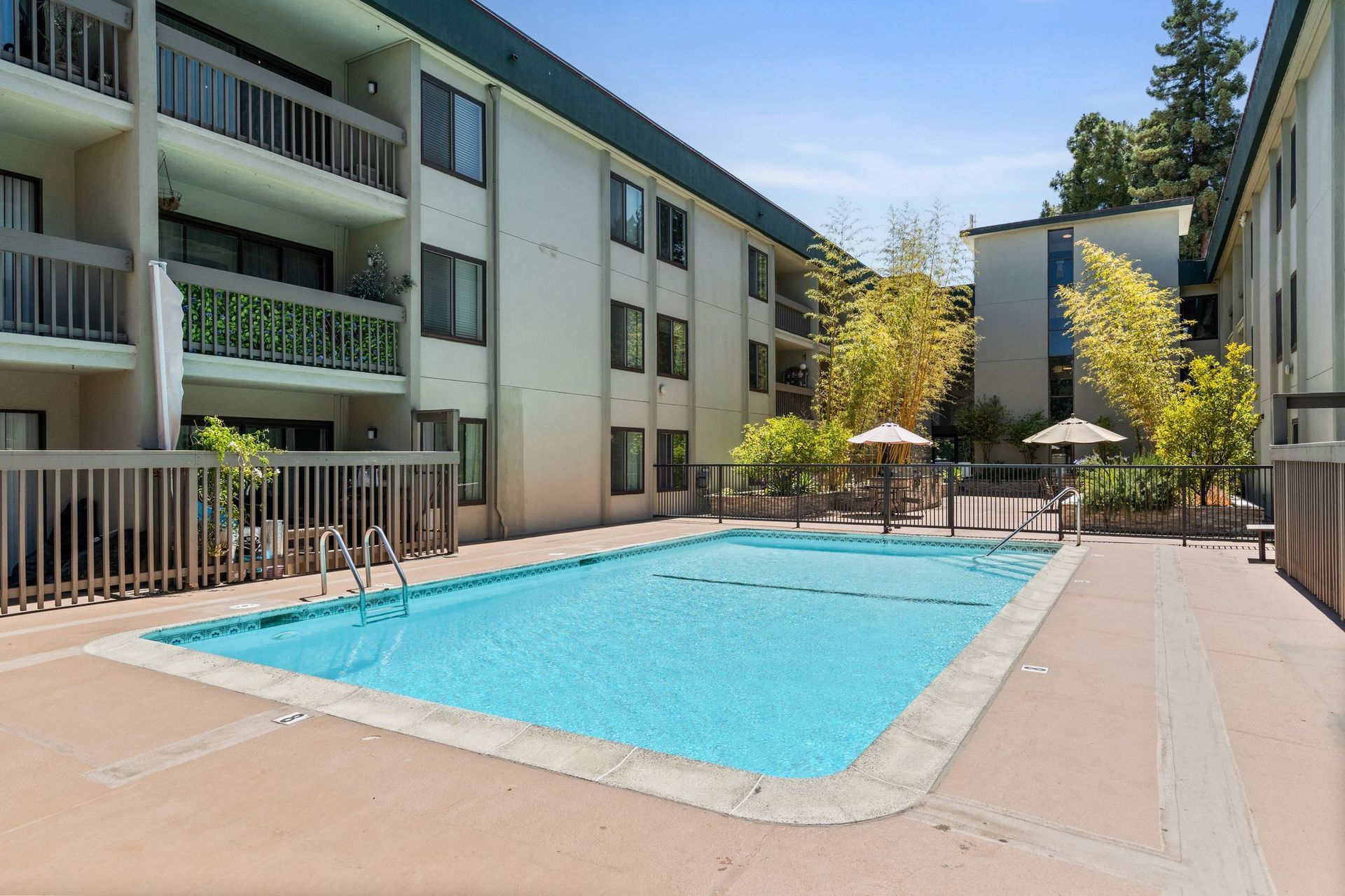 A large swimming pool in front of a building.