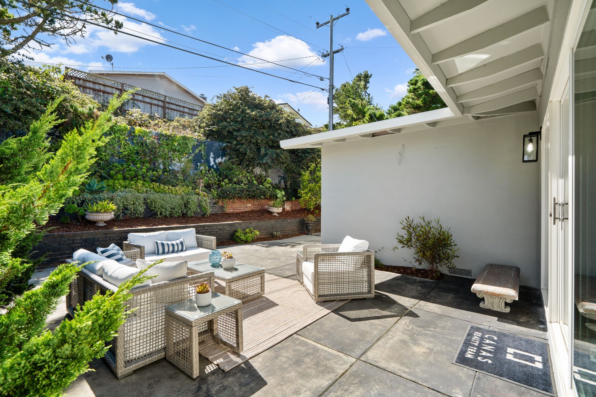 There is a patio with outdoor furniture.