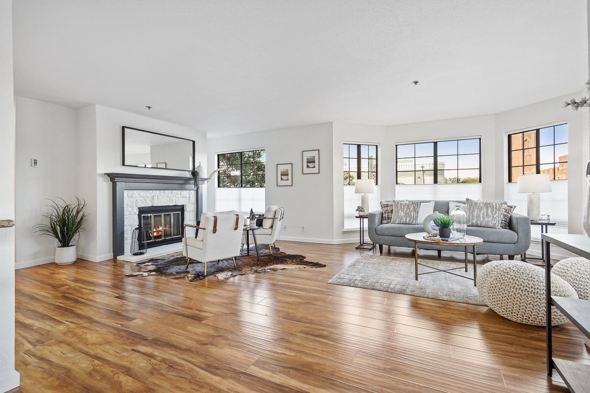 A living room with hardwood floors and a fireplace