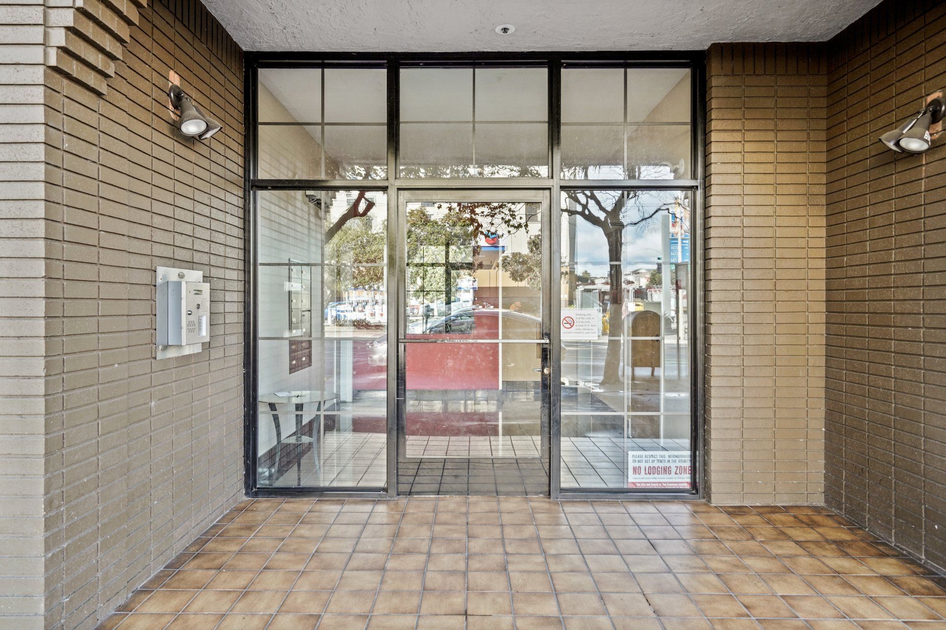 A building with a large glass door and a tiled floor